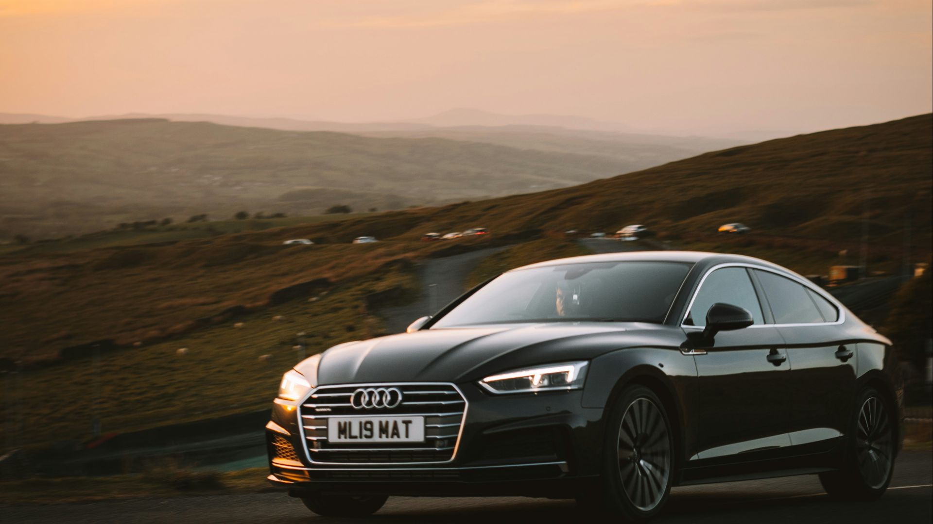 black audi a 4 on road during daytime