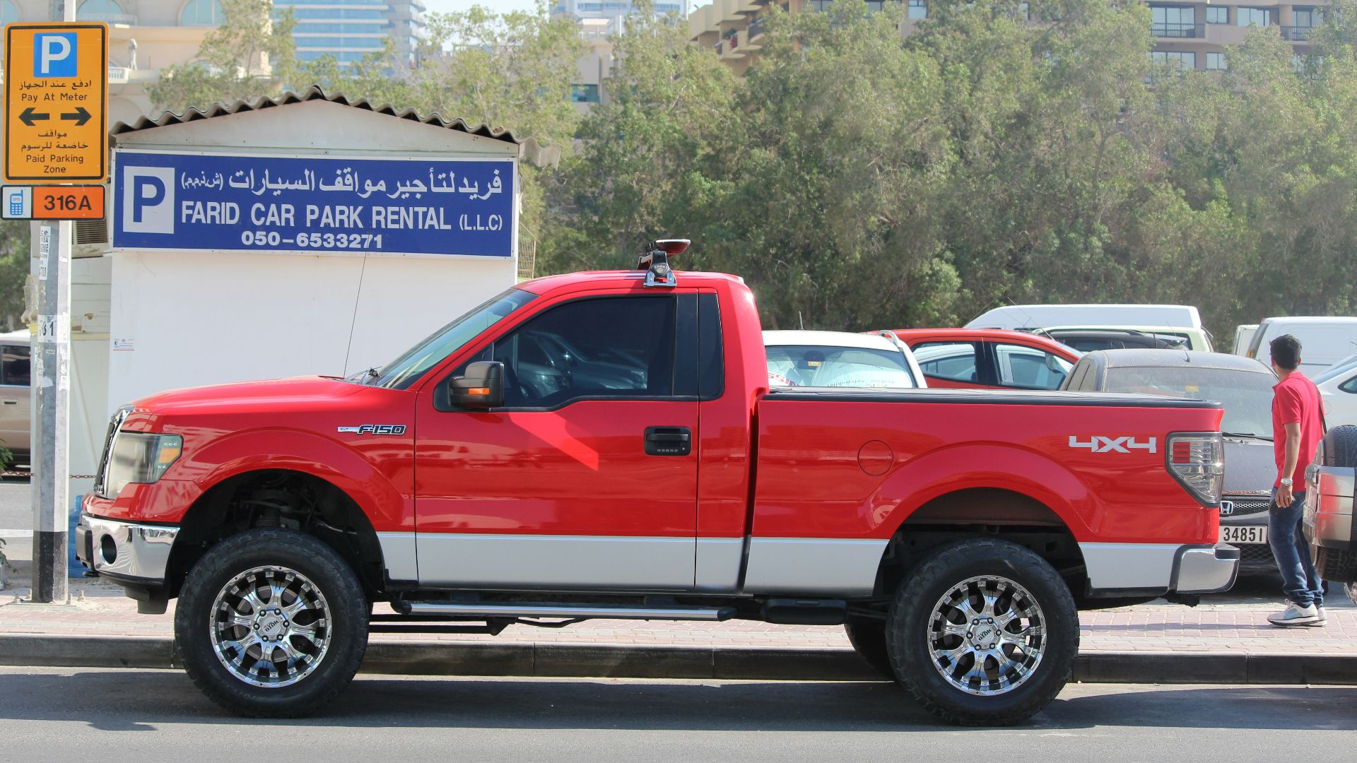 a red truck parked on the side of a road