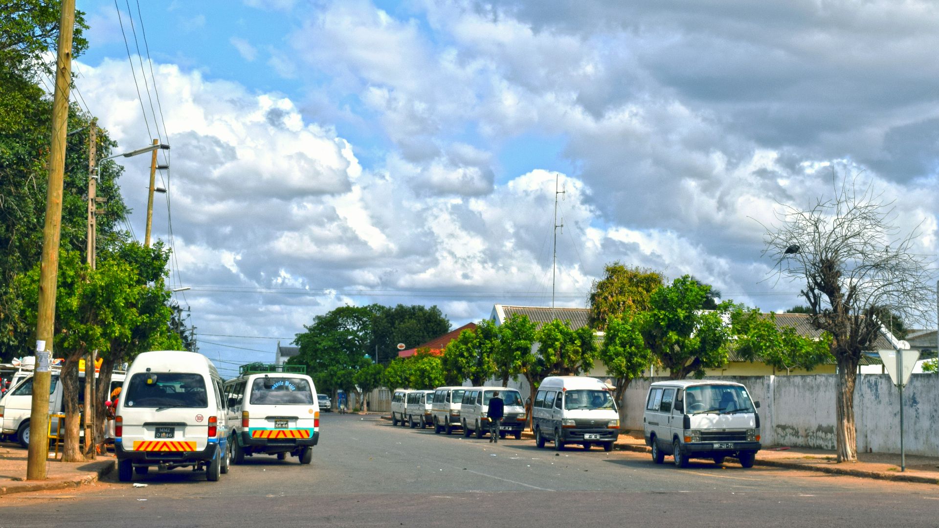 A group of cars parked on the side of a road