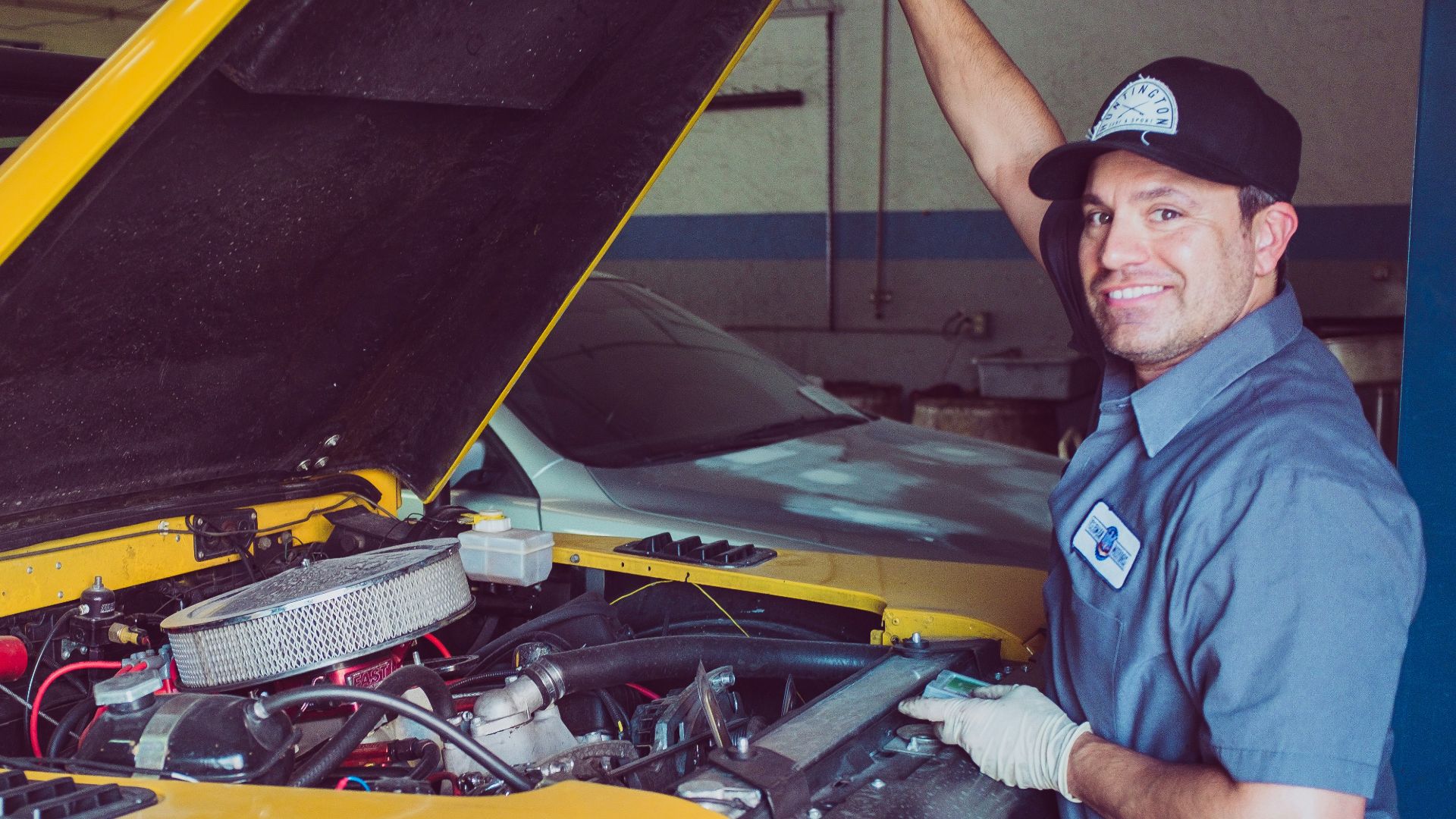 man holding open-wide car trunk