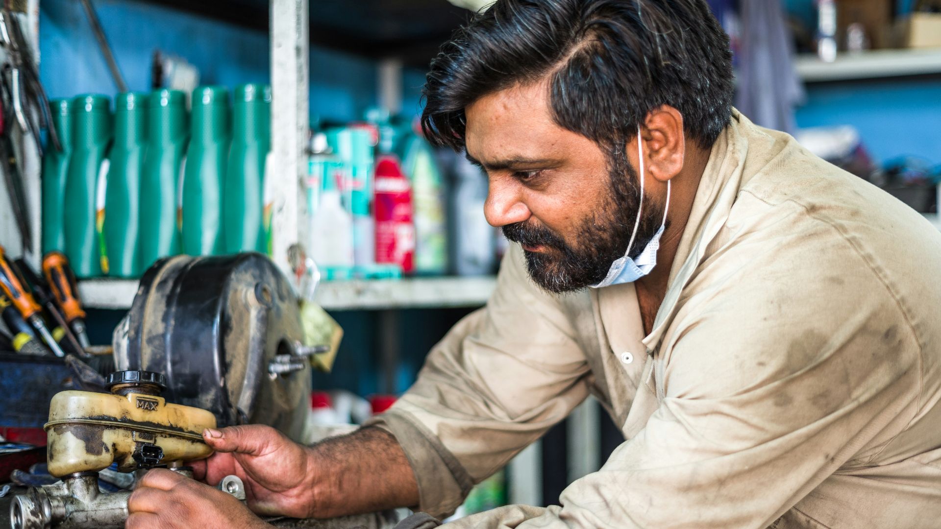 man in white dress shirt holding yellow and black power tool