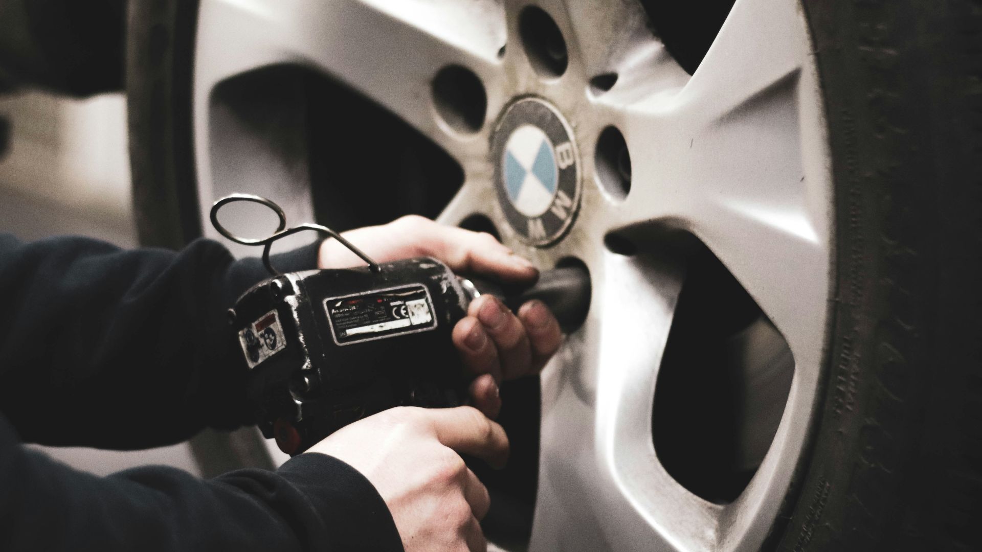 person in black jacket holding black smartphone