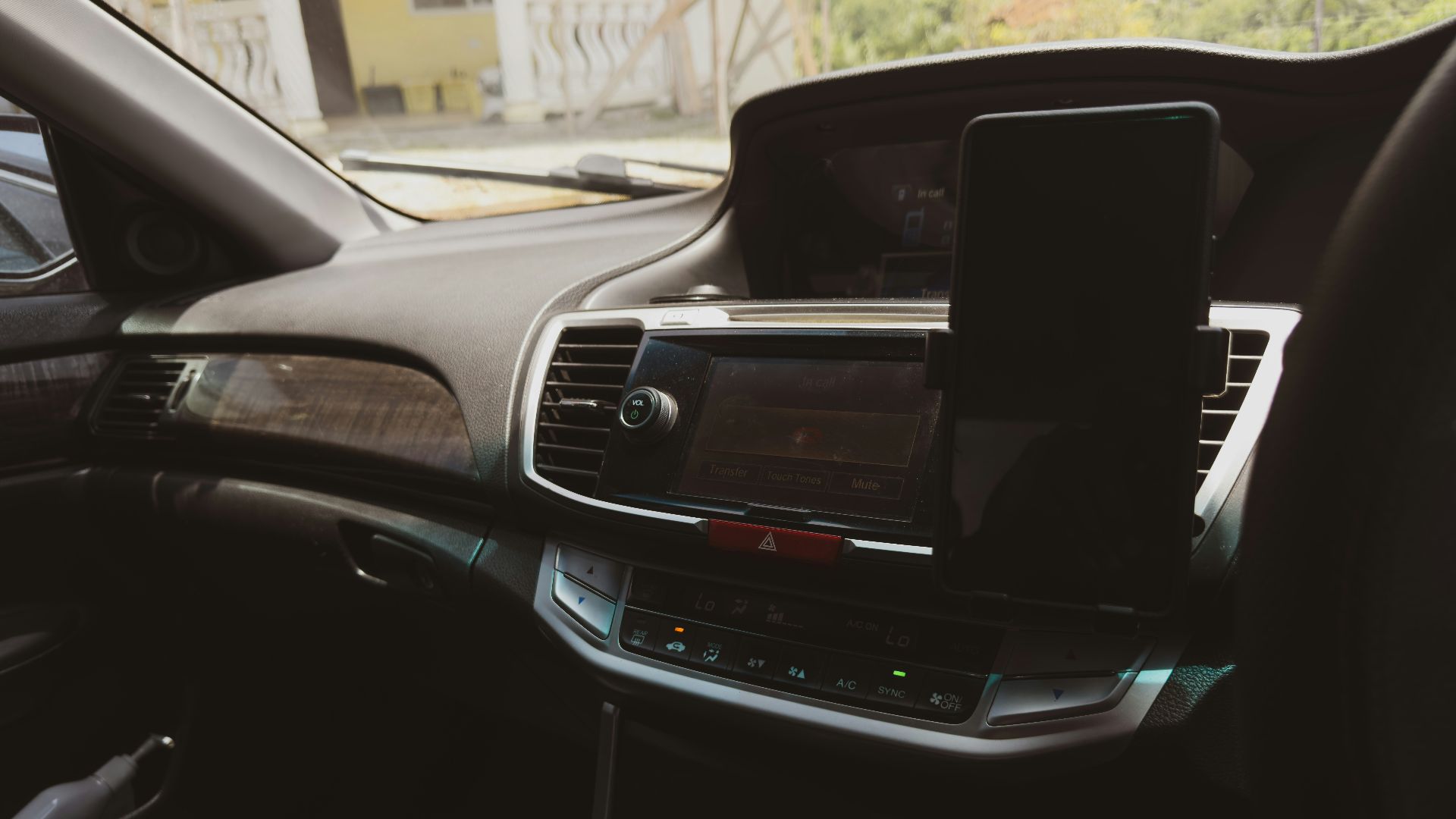 the dashboard of a car with a cell phone in it
