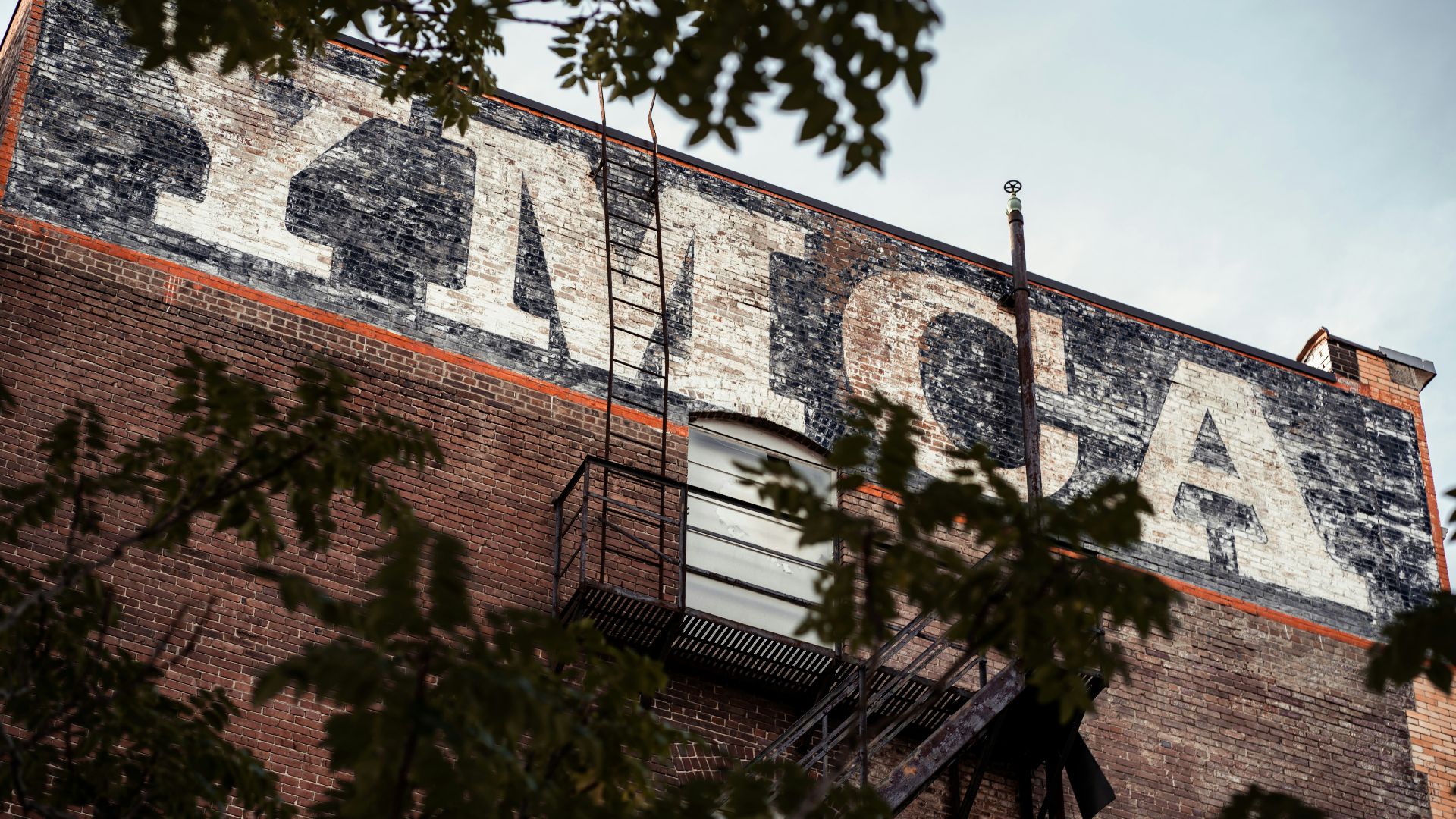 an old sign on the side of a building