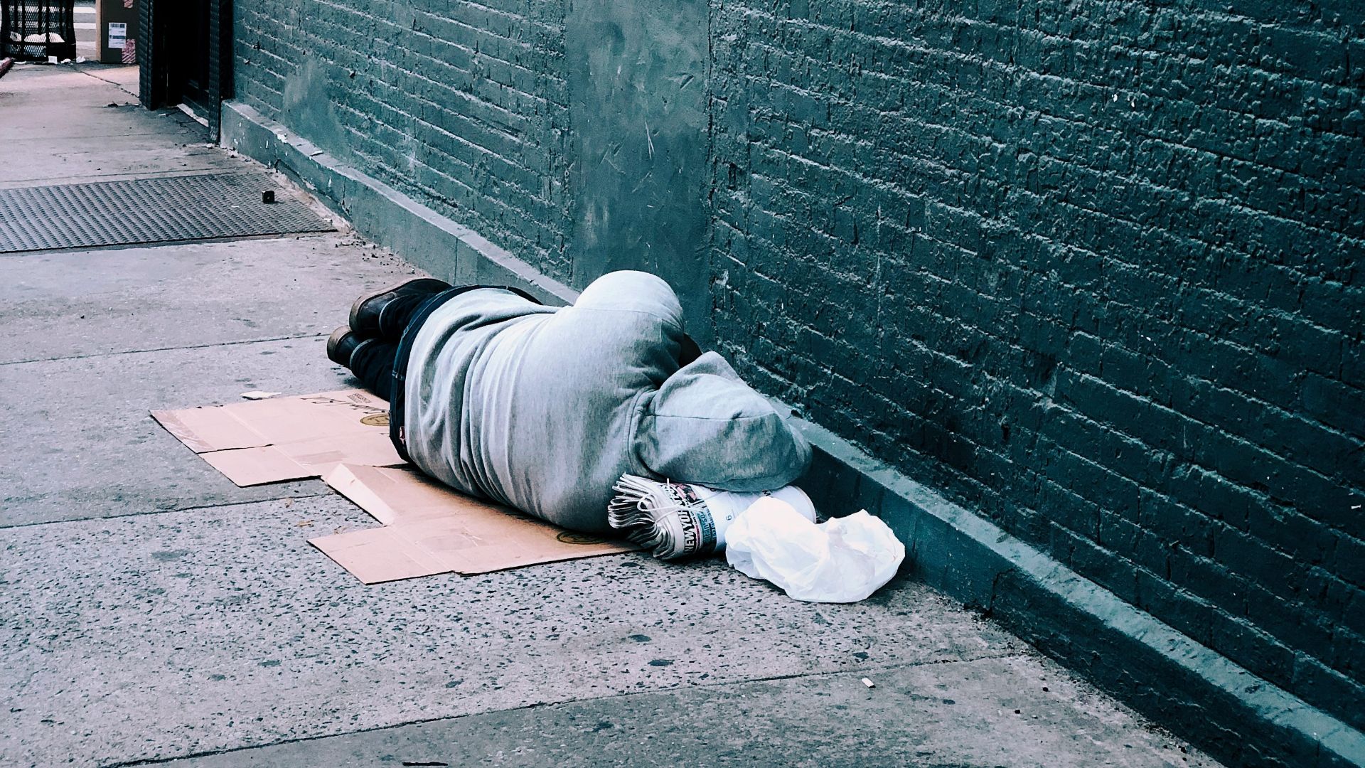 man lying on brown cardboard box
