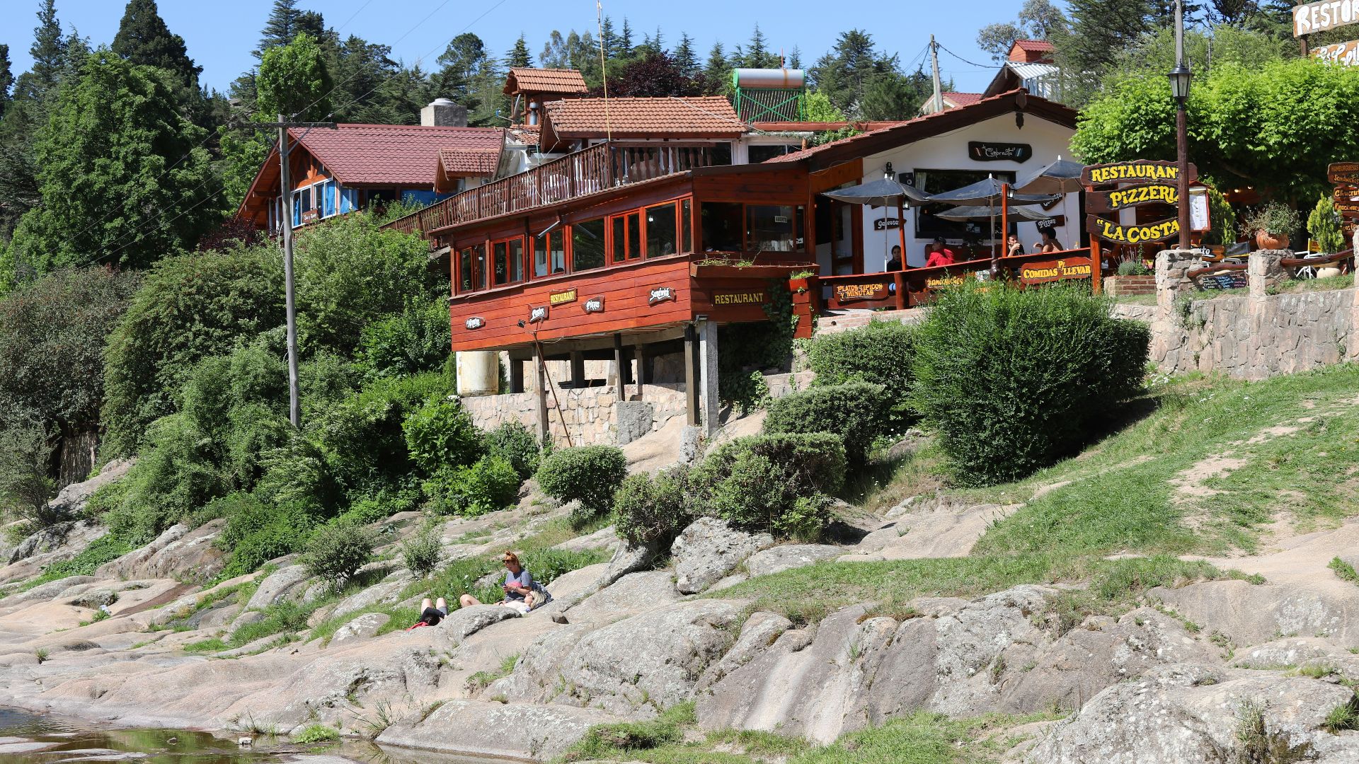 A scenic view of buildings beside a river.