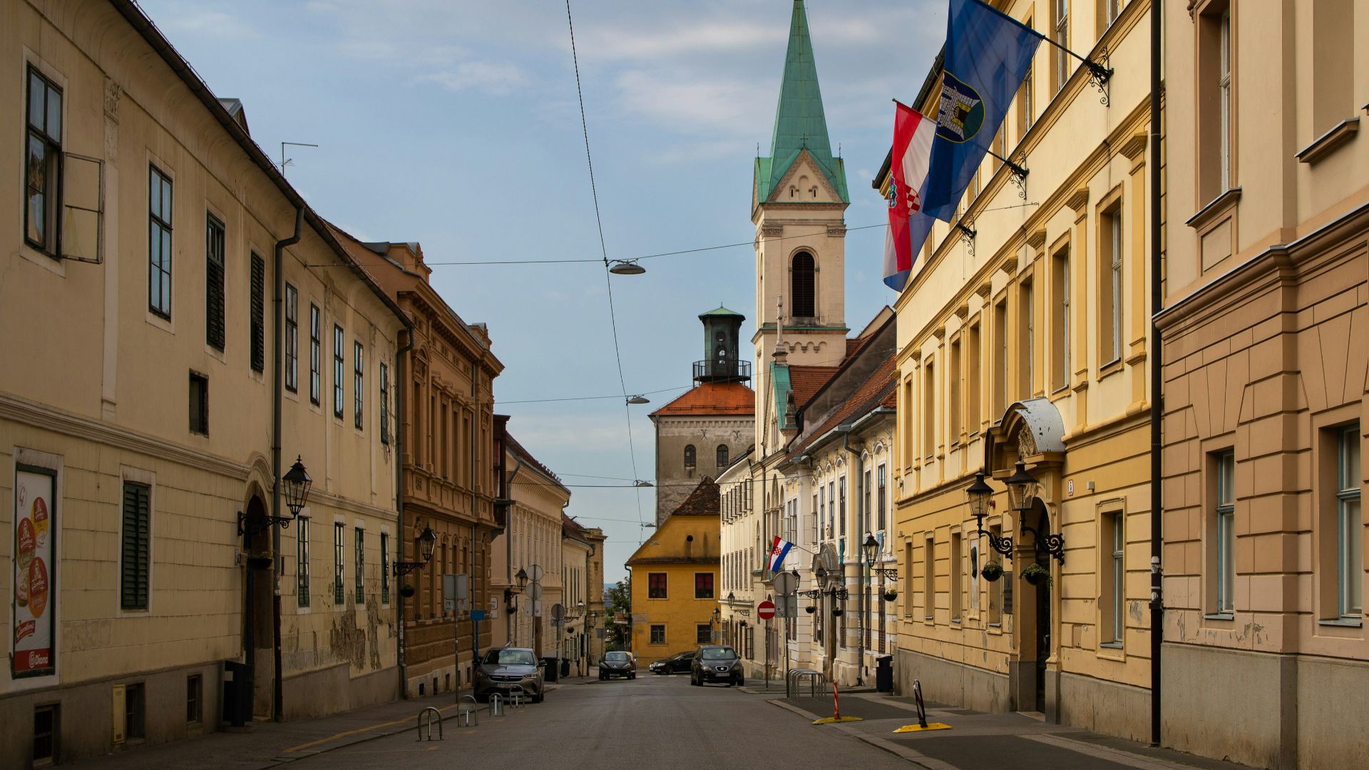 a street with buildings and flags on it