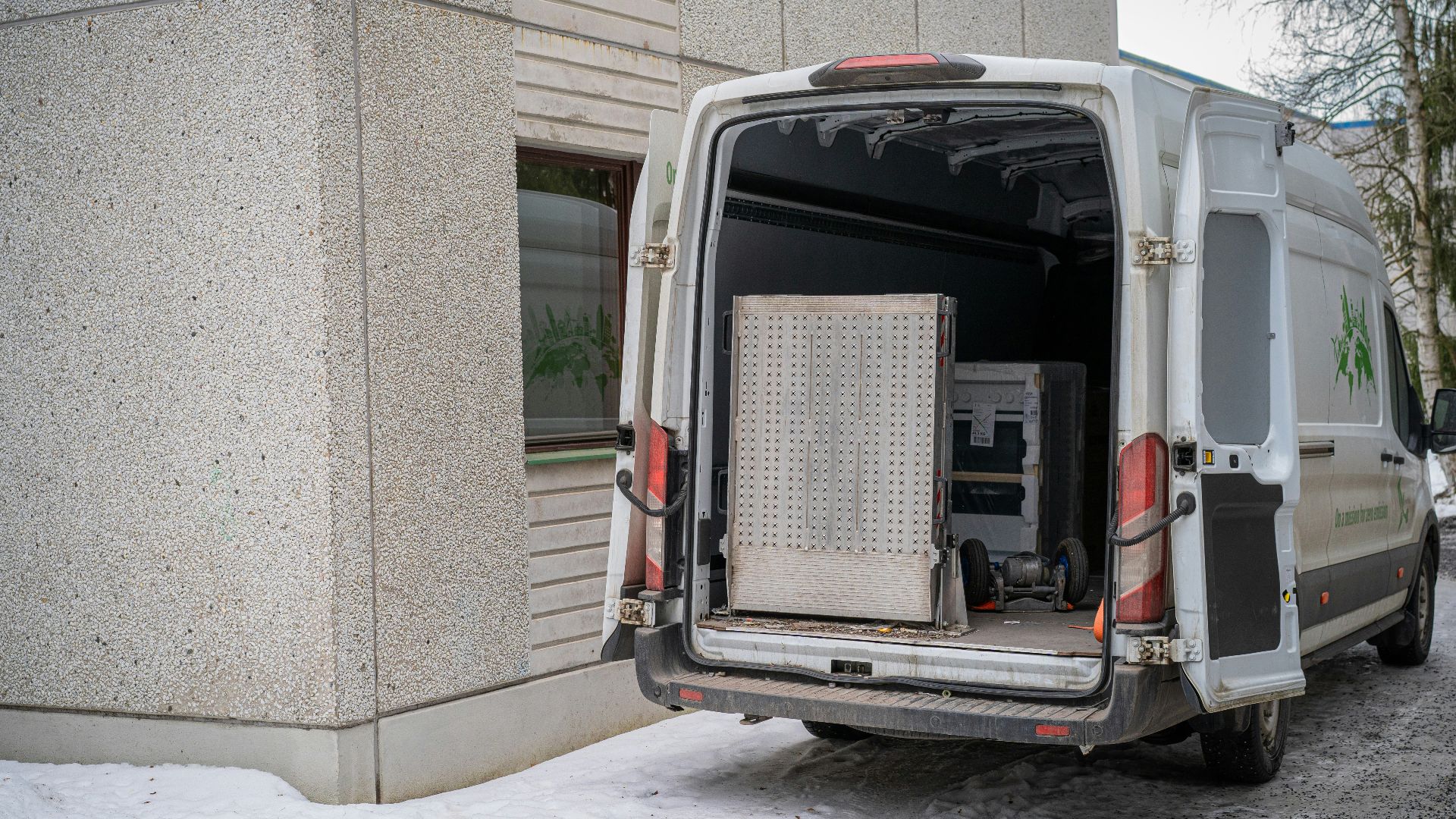 A delivery van with its back doors open.