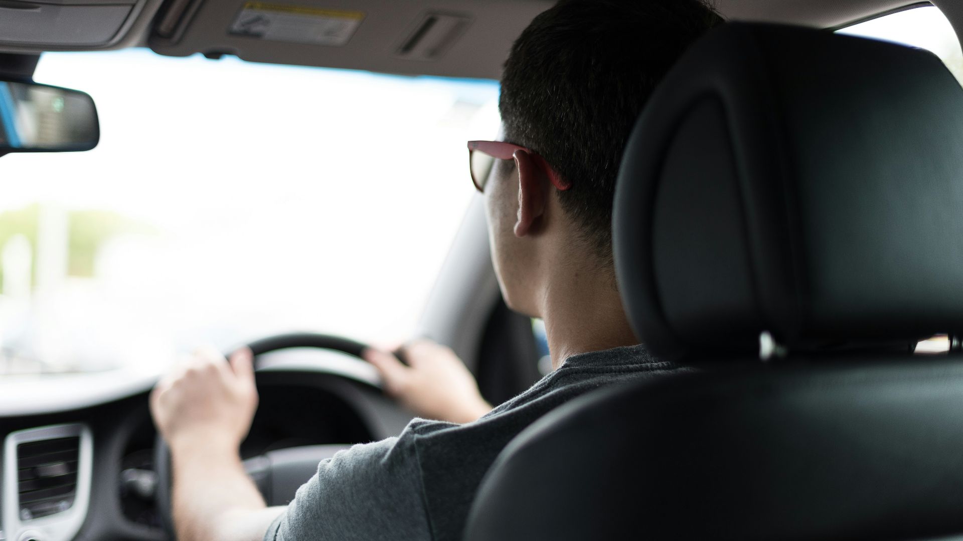 man driving car during daytime