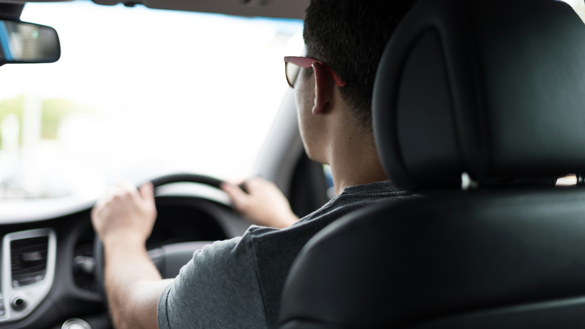 man driving car during daytime