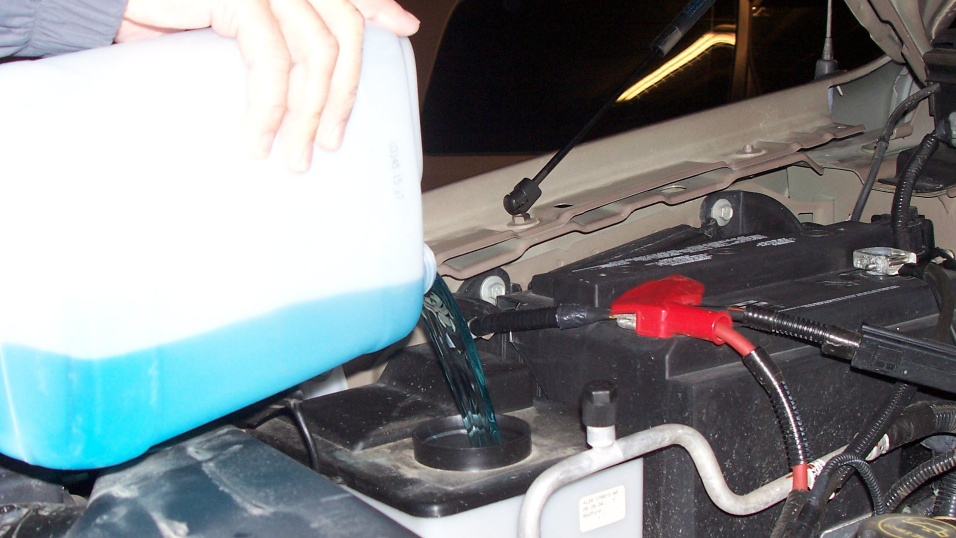 File:Man pouring windshield washer fluid.jpg