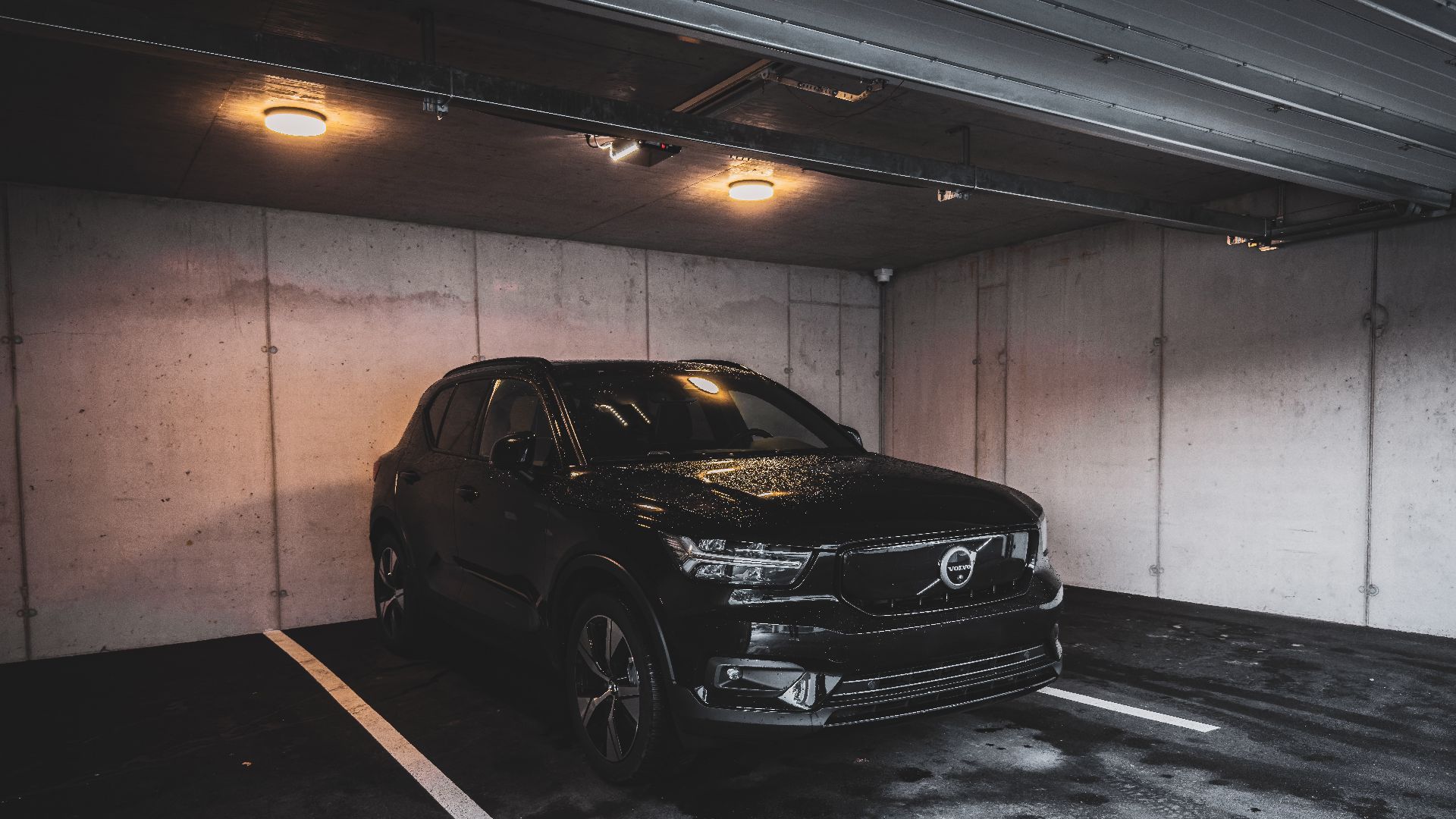 a black car parked in a parking garage