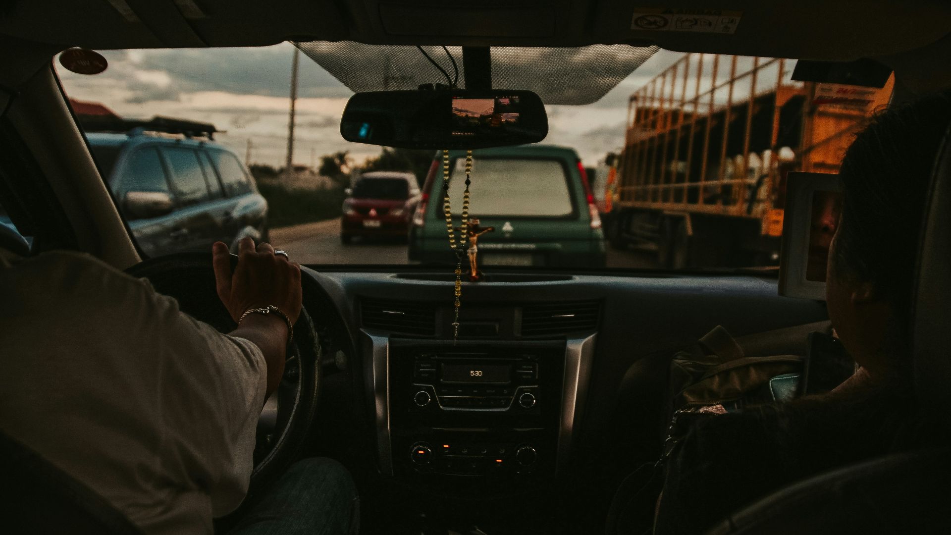a man driving a car down a street