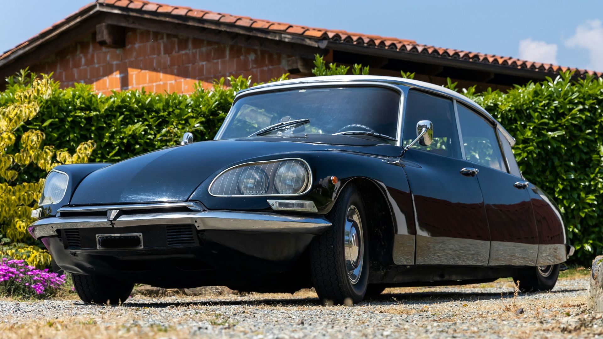 a black car parked in front of a house