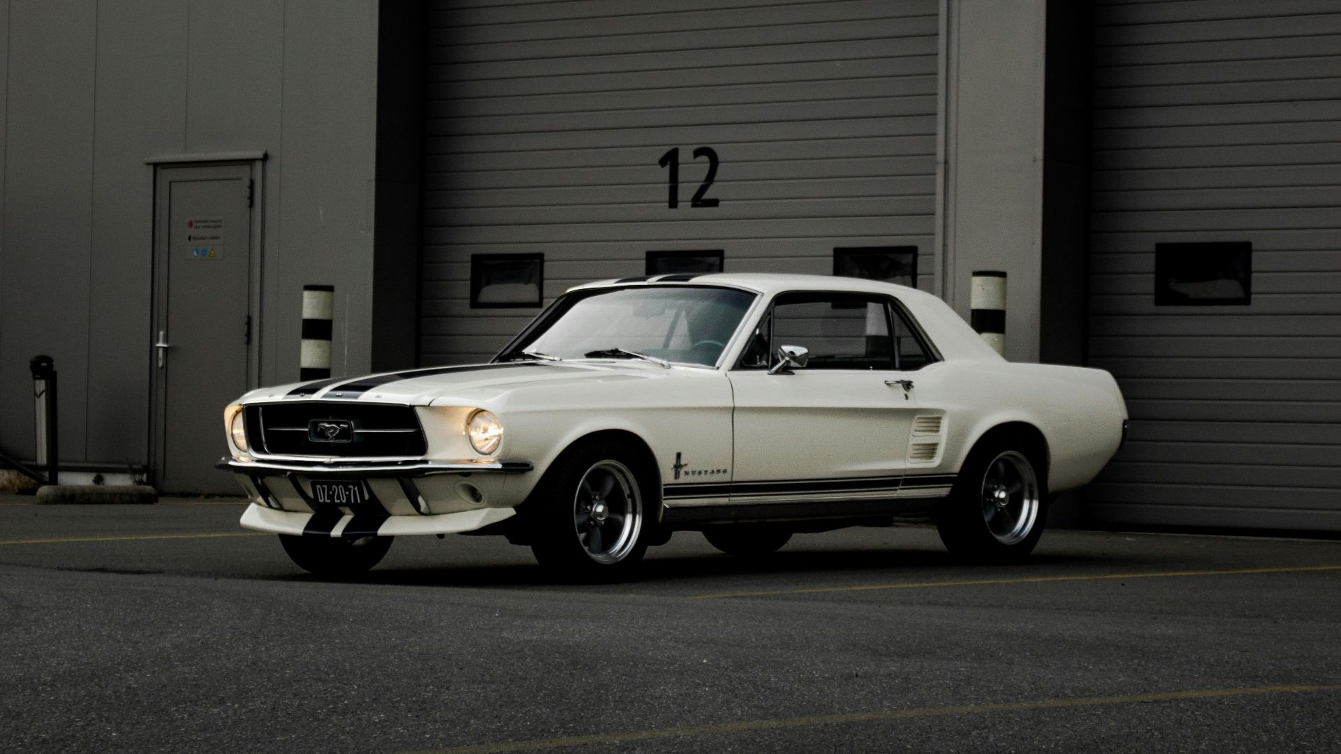 white chevrolet camaro parked in front of garage