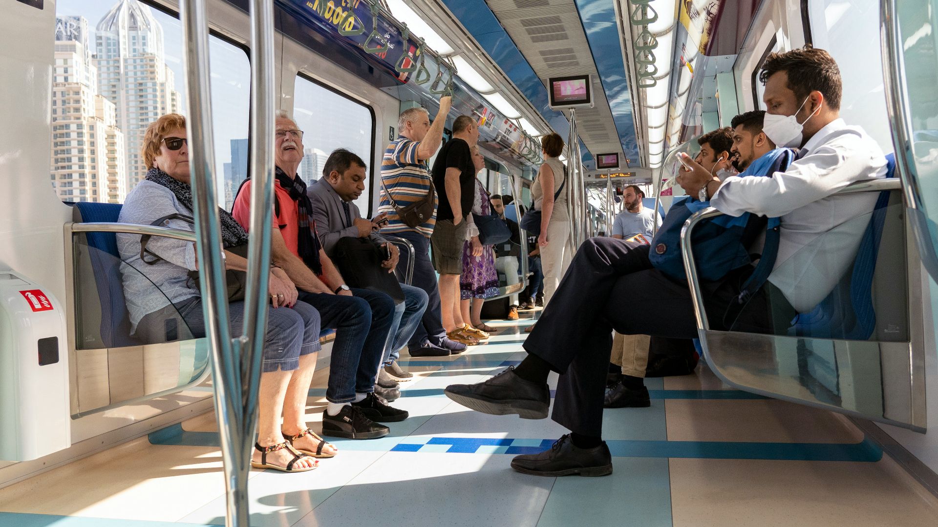 people sitting on blue and white train seat