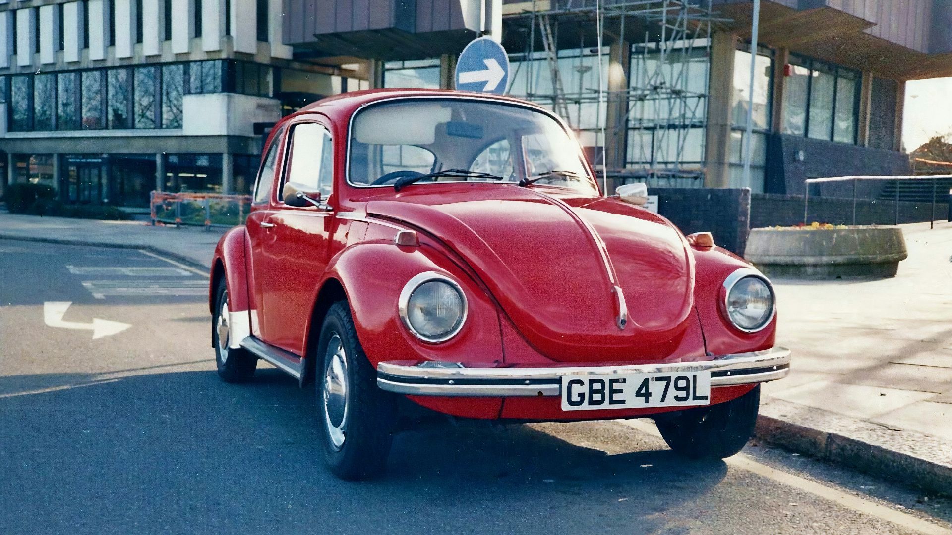 red classic car parked on street during daytime