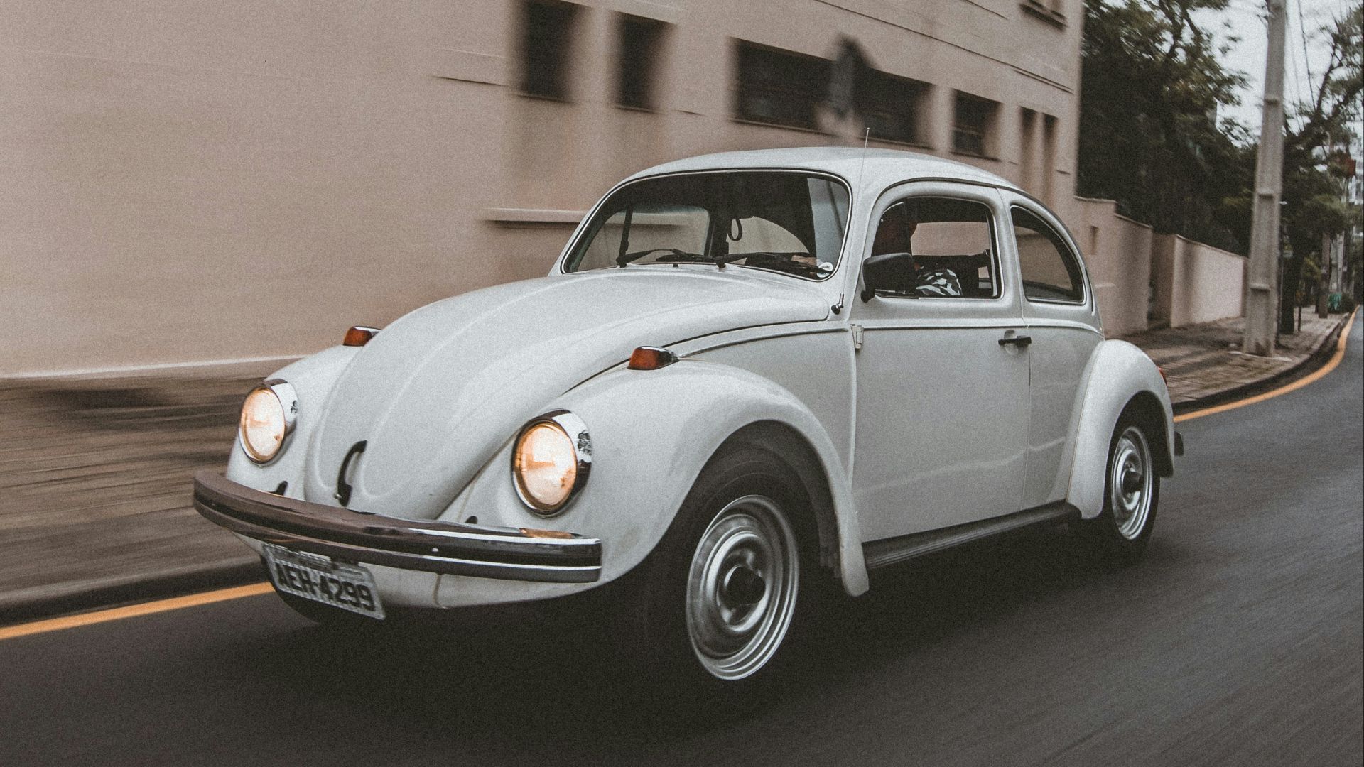 white classic car on road during daytime