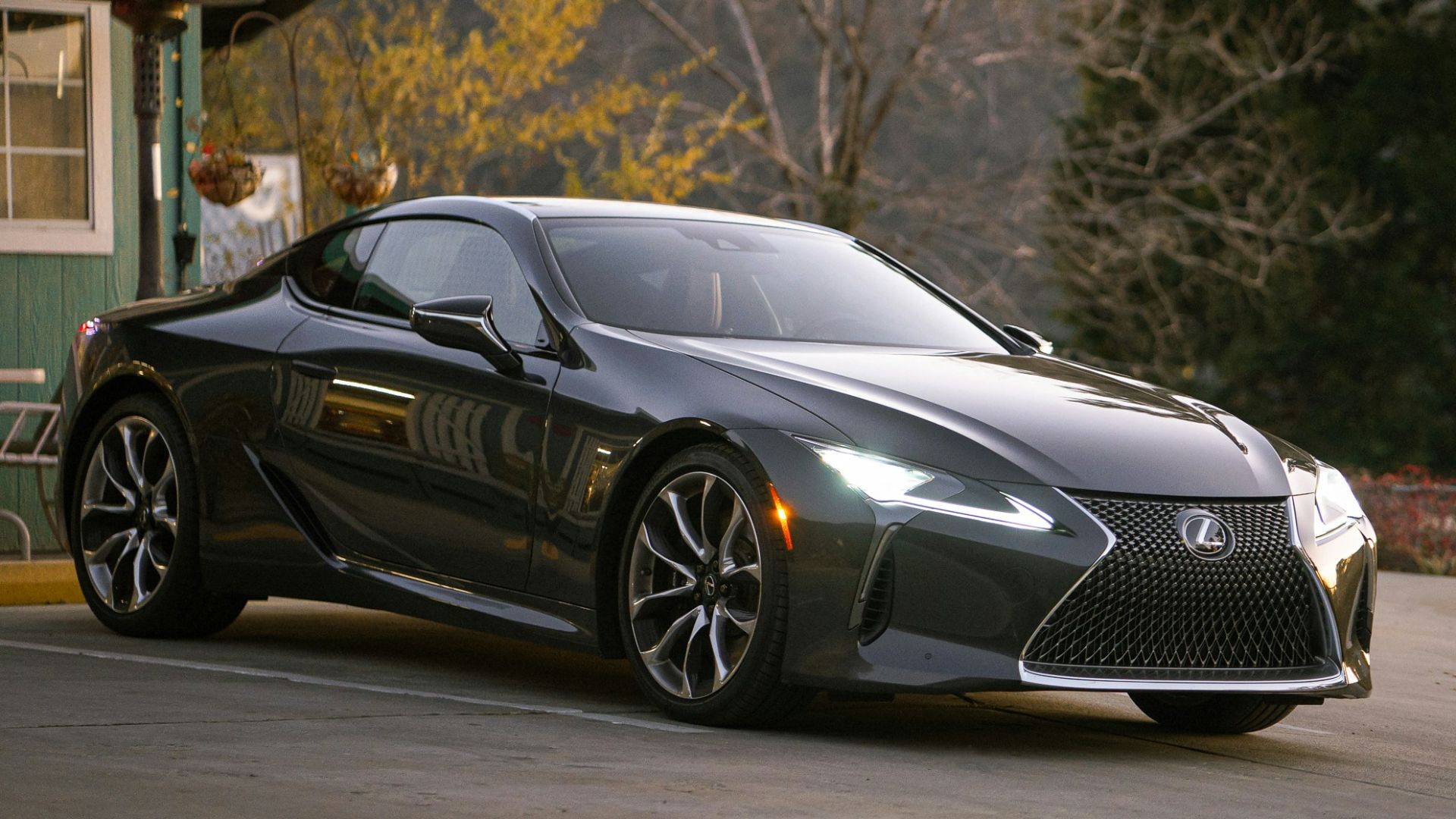 gray Lexus coupe parked in front of building