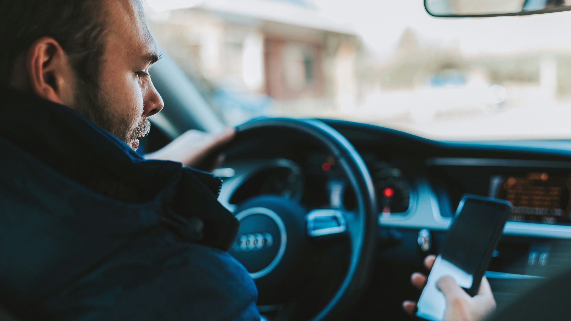 man holding black smartphone