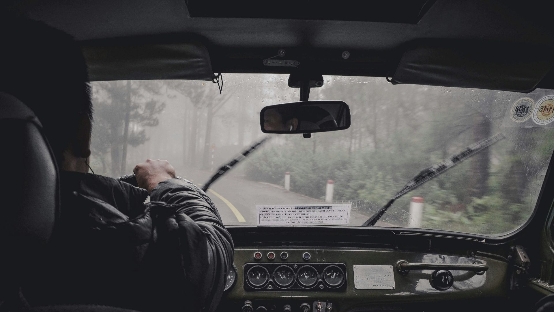 man driving car during rainy daytime