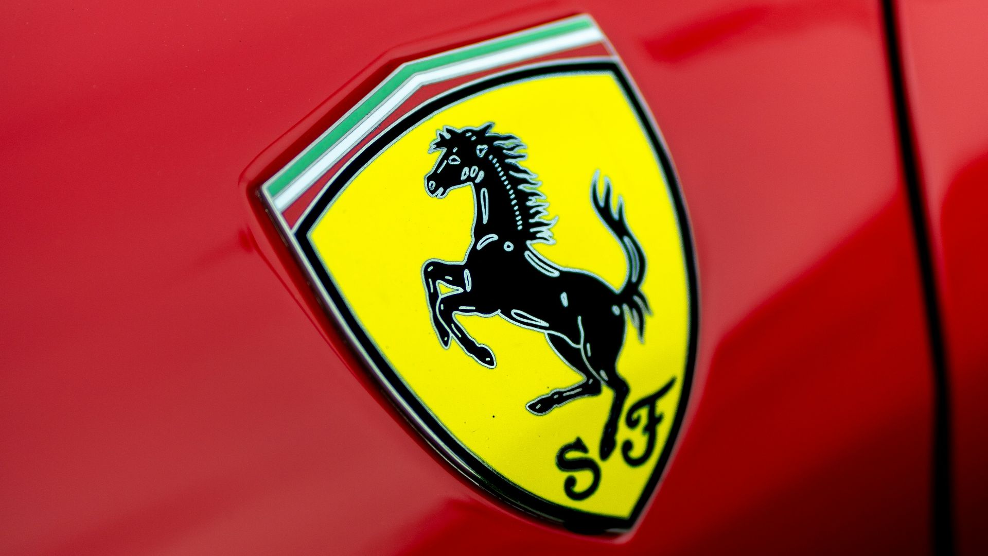 a close up of a ferrari badge on a red car