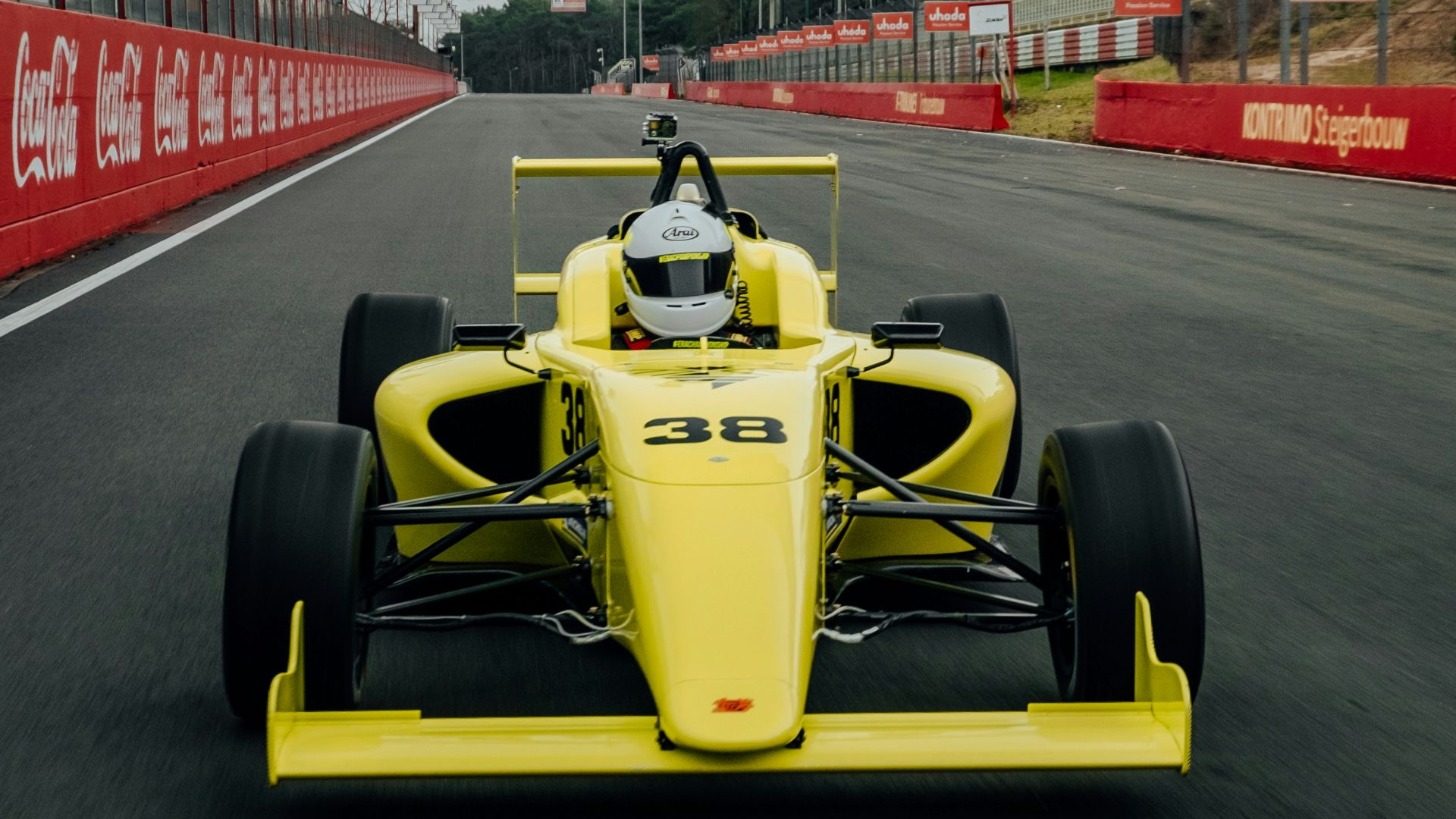yellow and black f 1 car on road during daytime