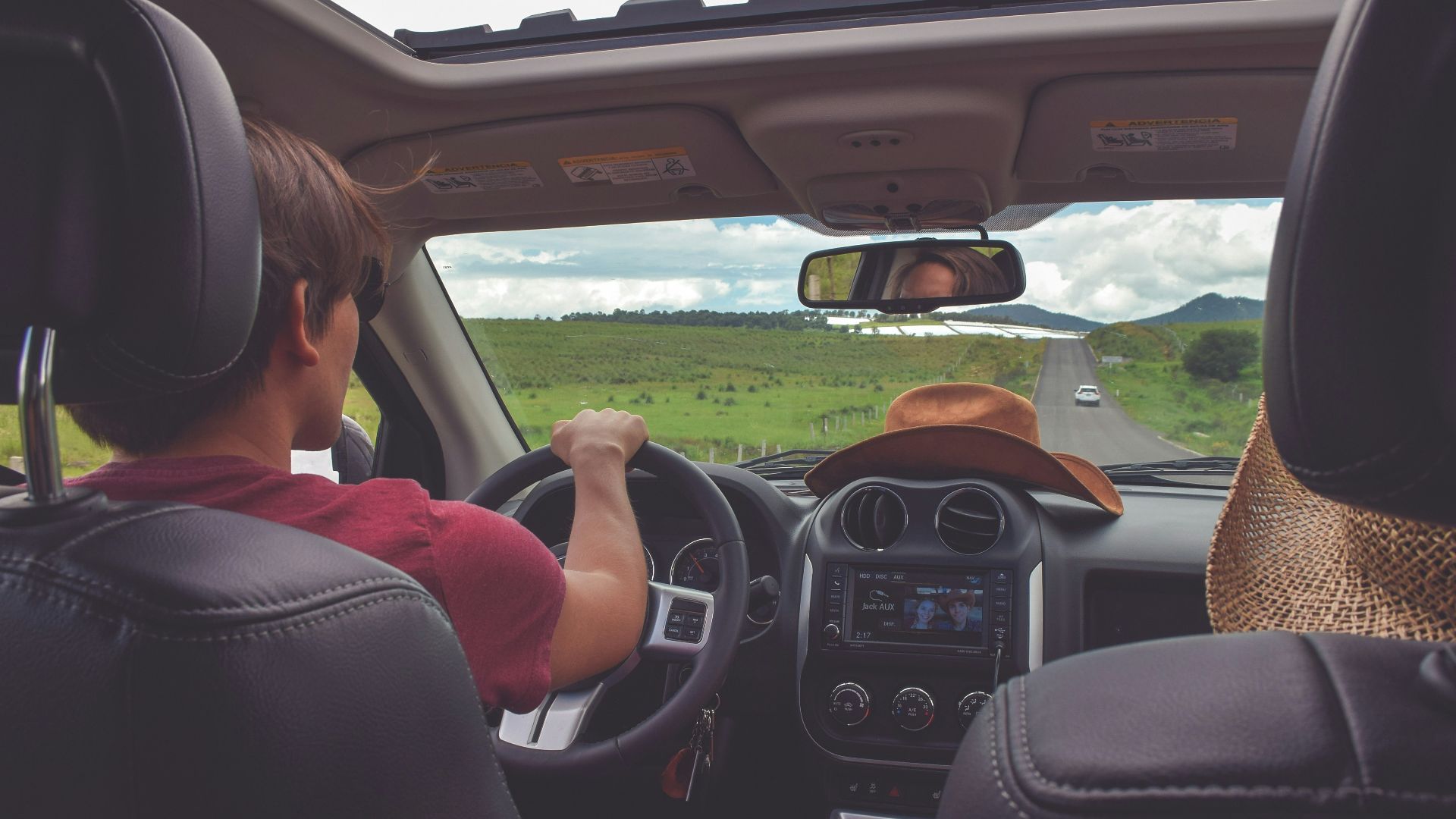 man driving straight on pathway during day time