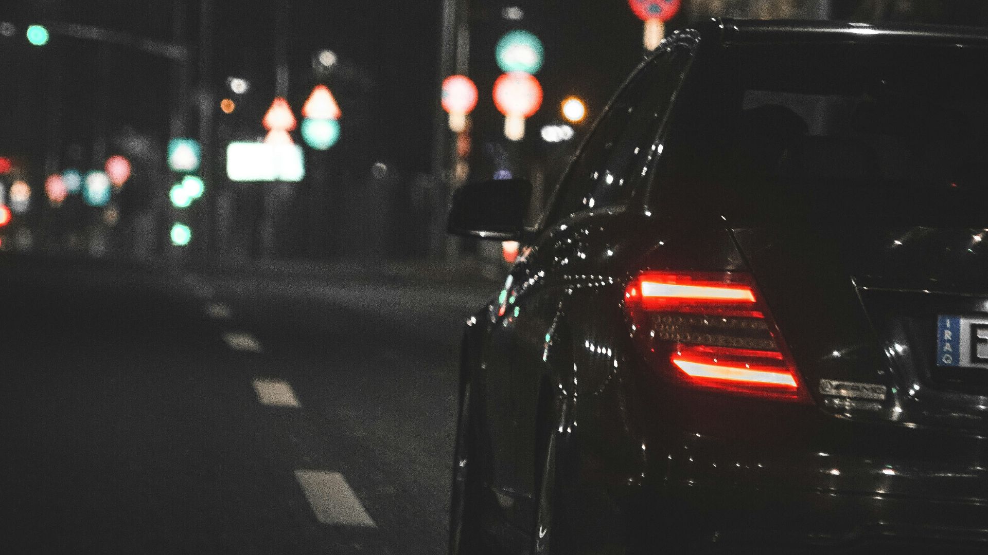 black car on road during night time