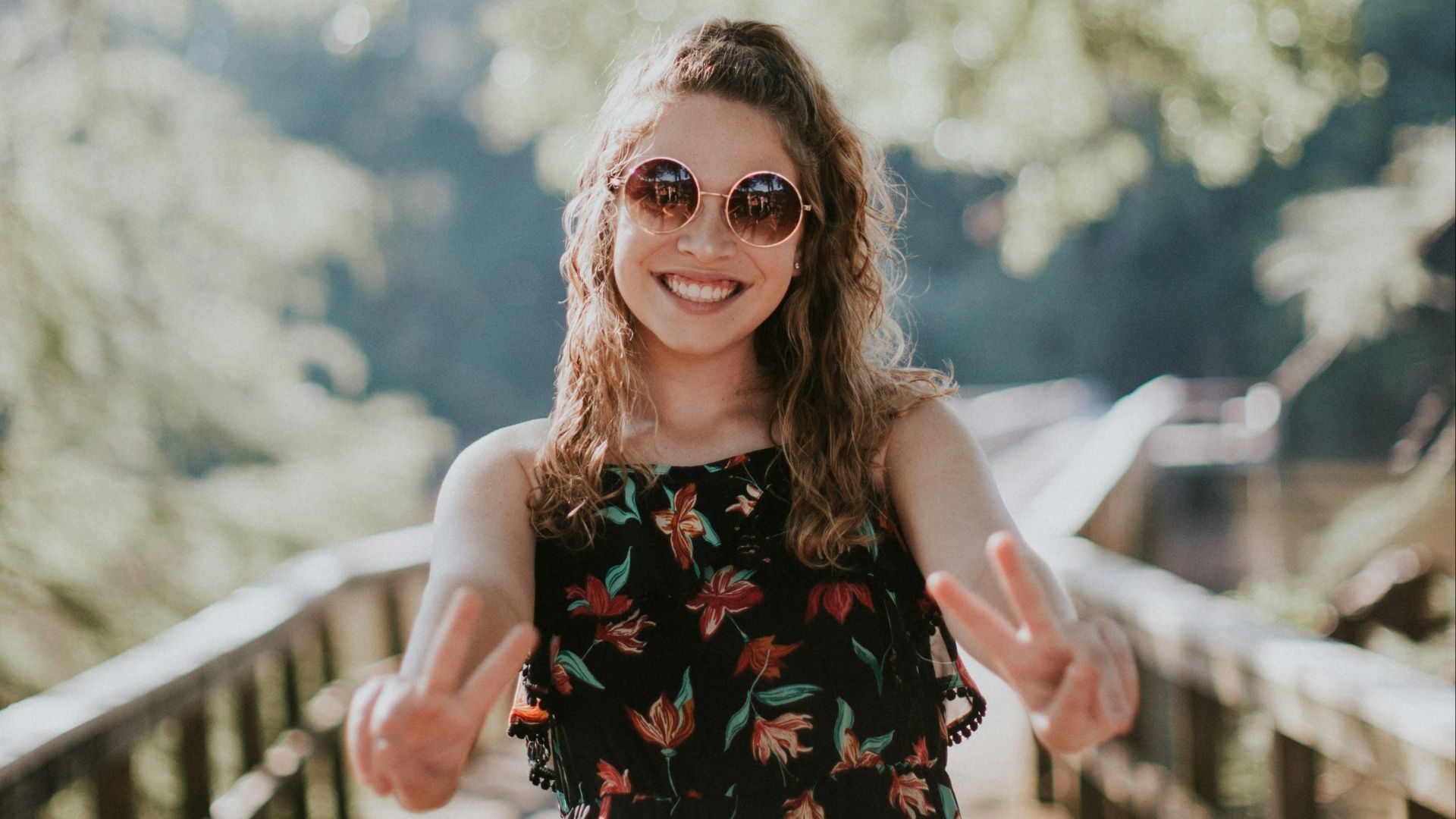 woman standing on wooden bridge
