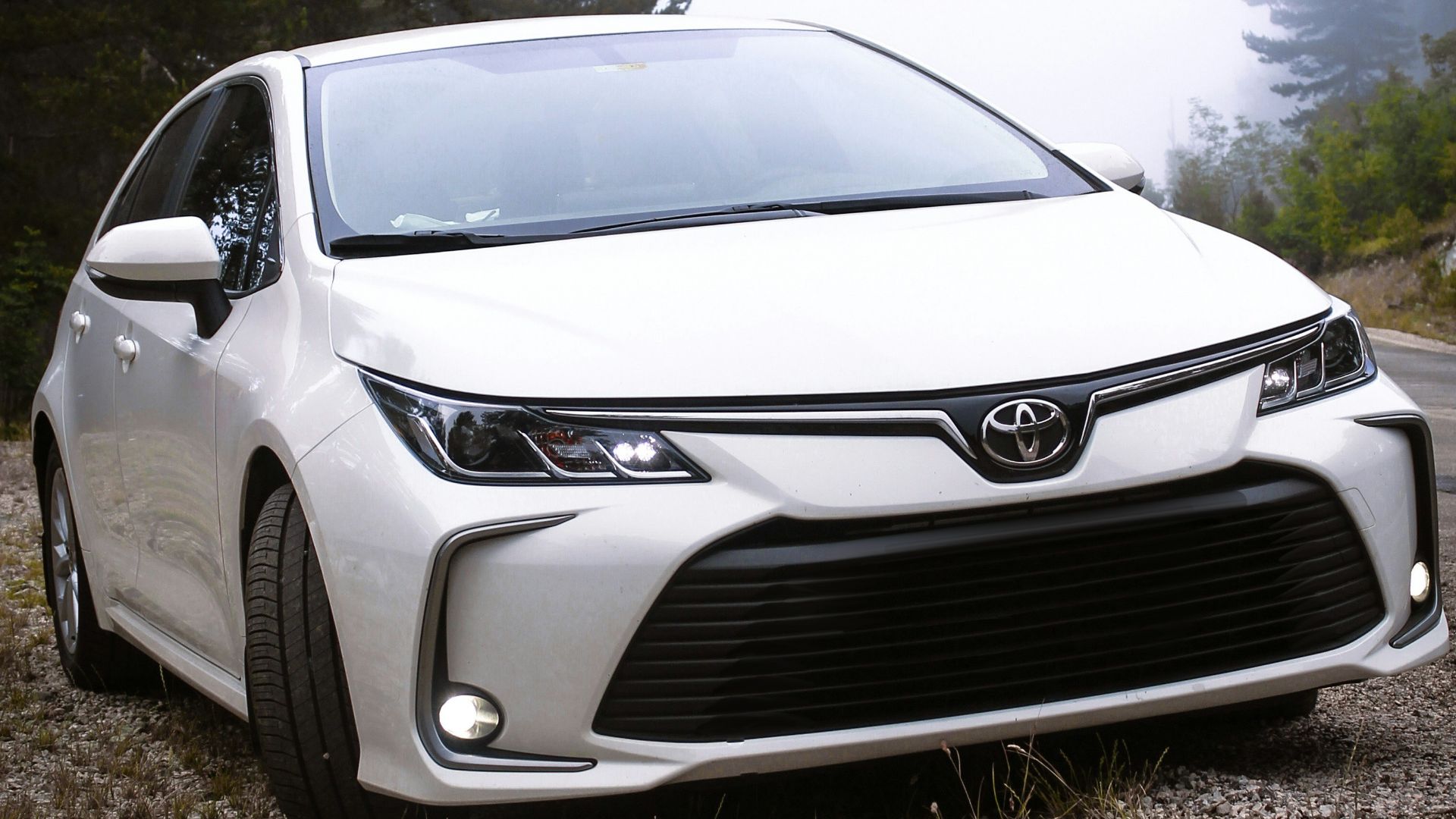 a white car parked on the side of a road