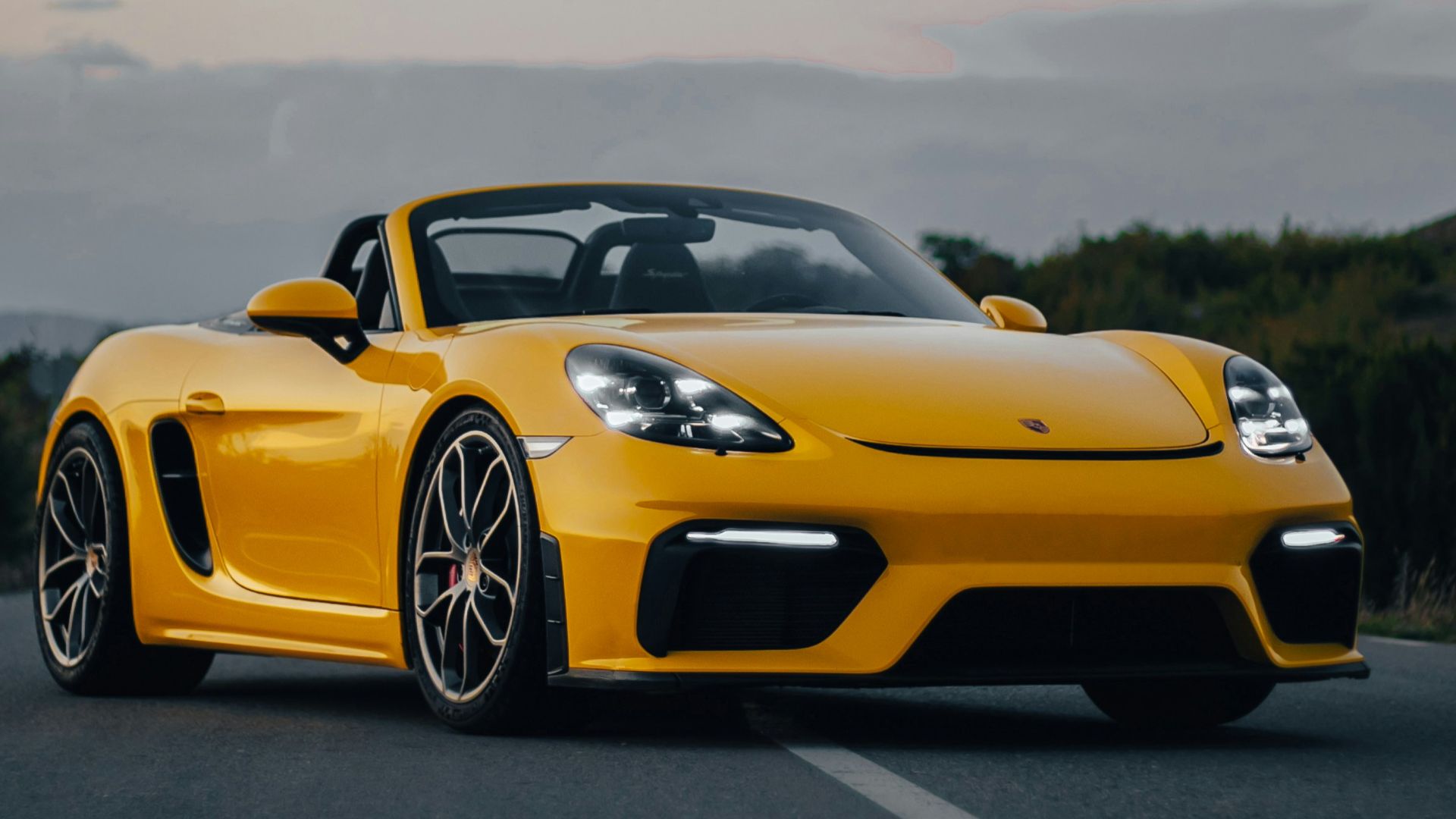 a yellow sports car parked on the side of the road