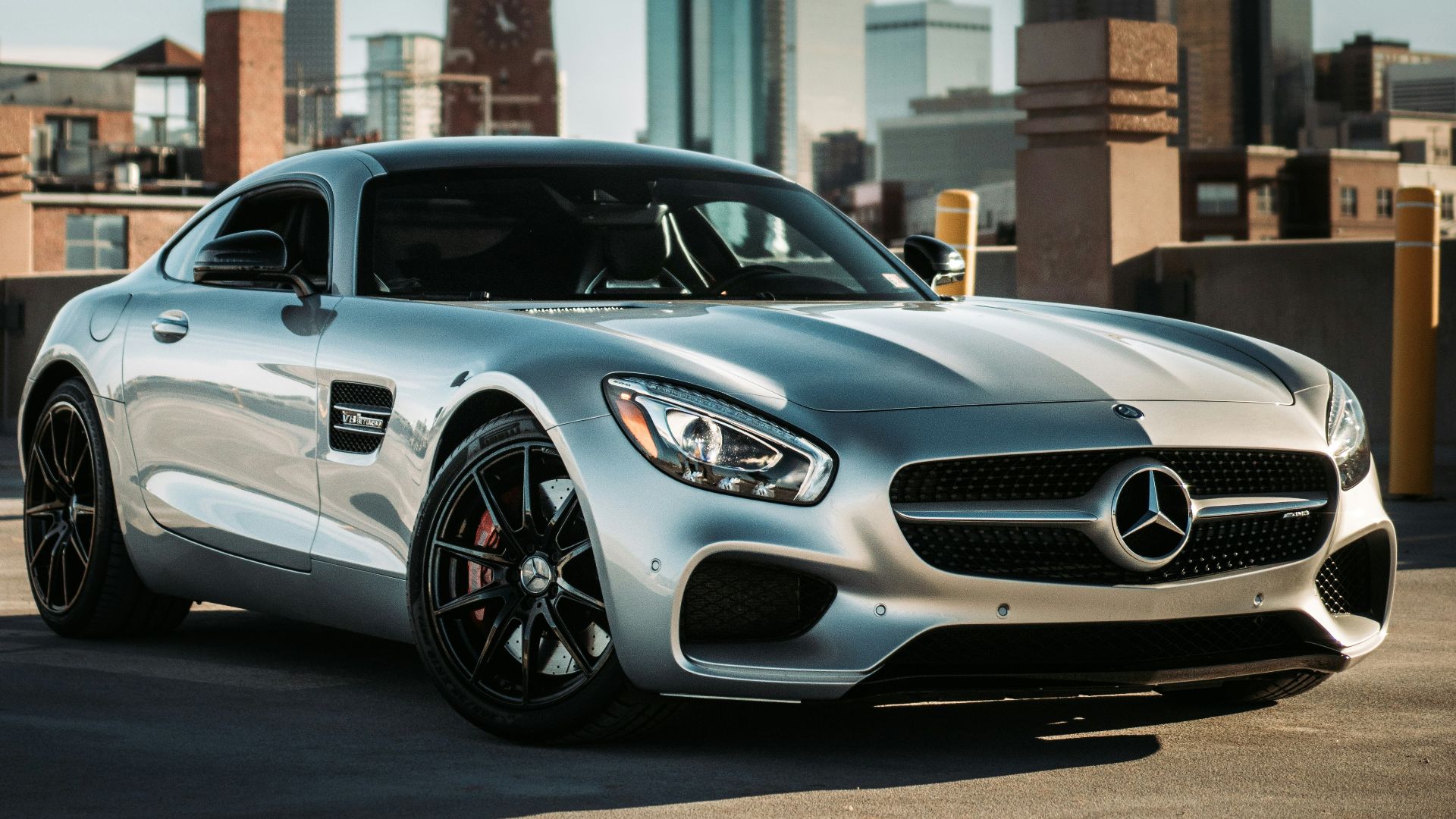silver mercedes benz coupe parked on gray concrete road during daytime