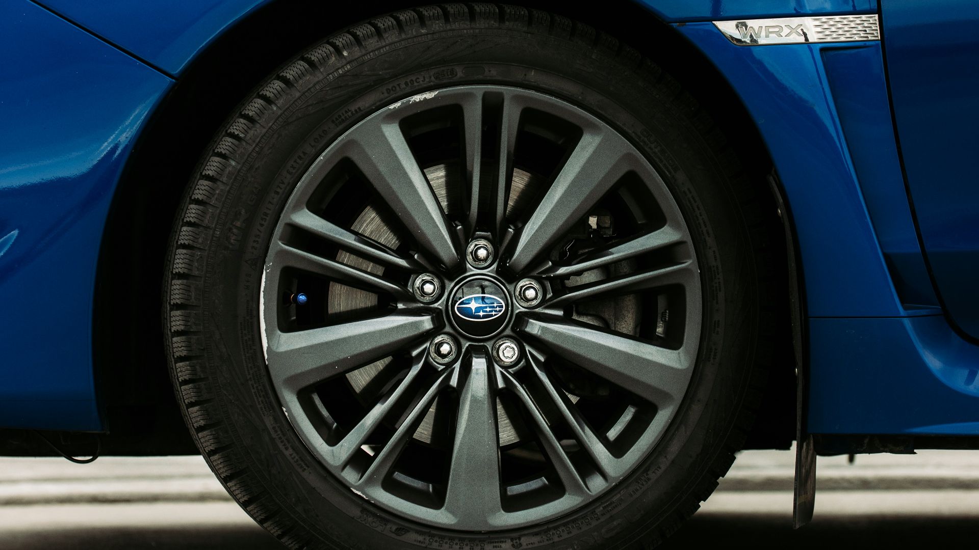 blue car on gray asphalt road during daytime