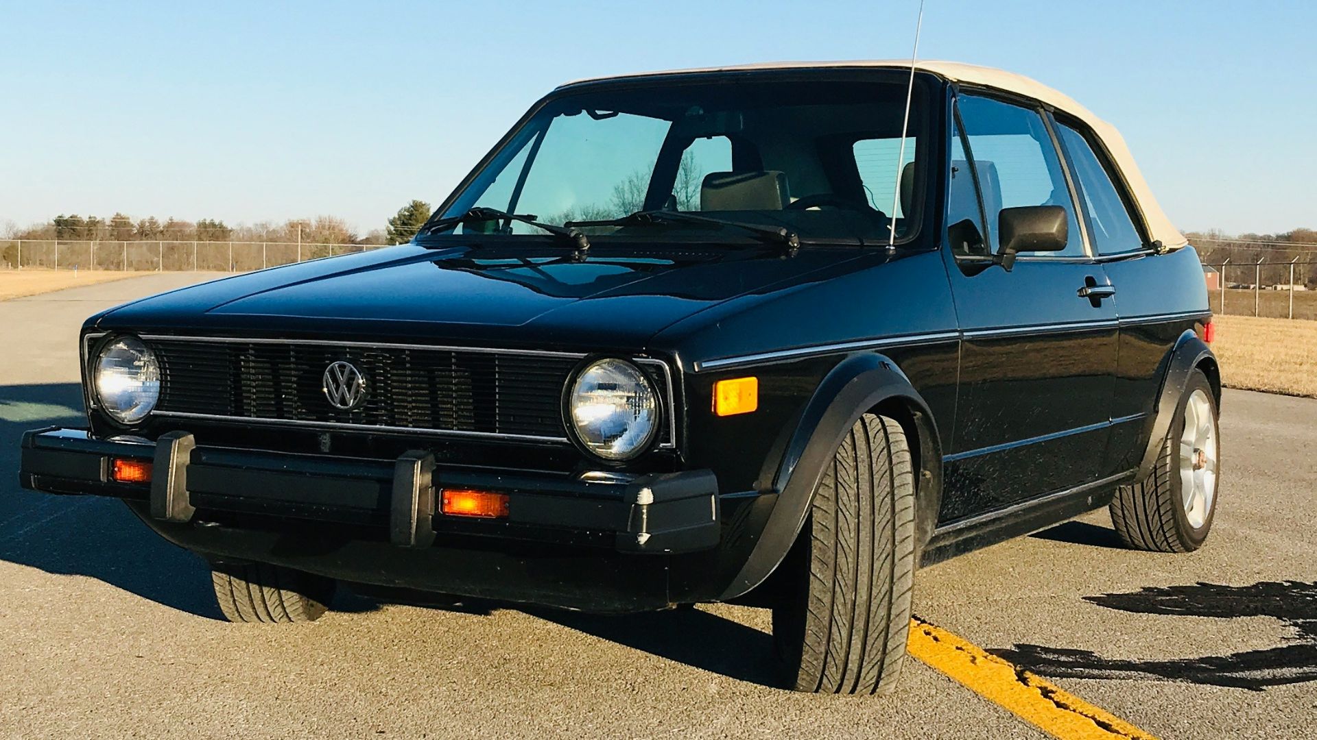 black chevrolet camaro on road during daytime