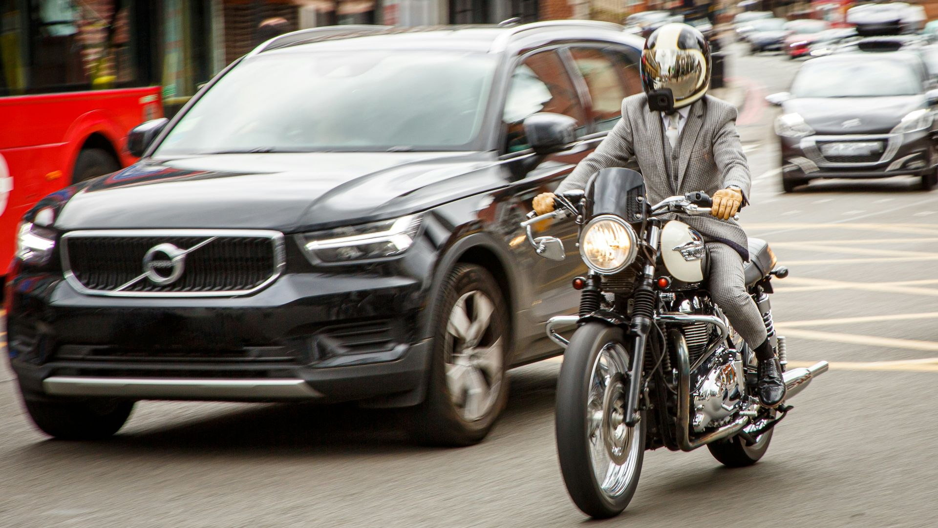 man in gray jacket riding motorcycle