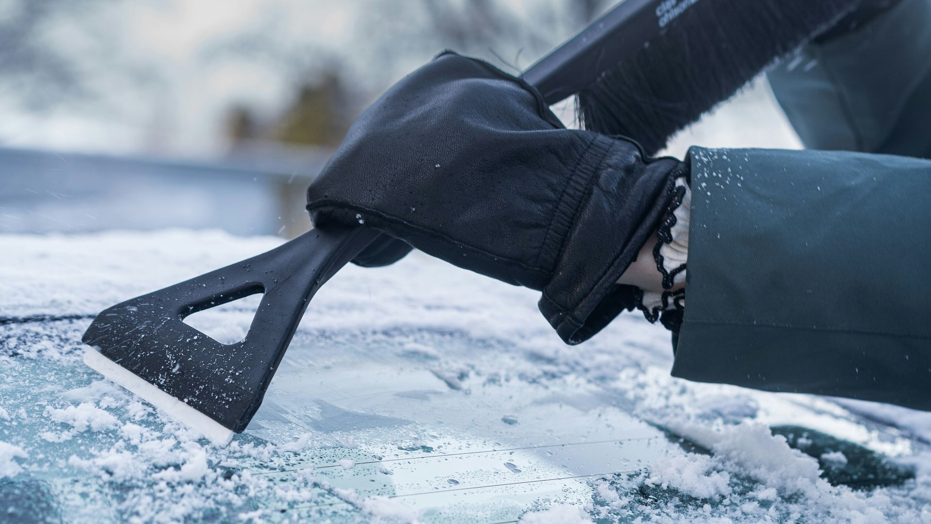 A person with a snowboard on top of a car
