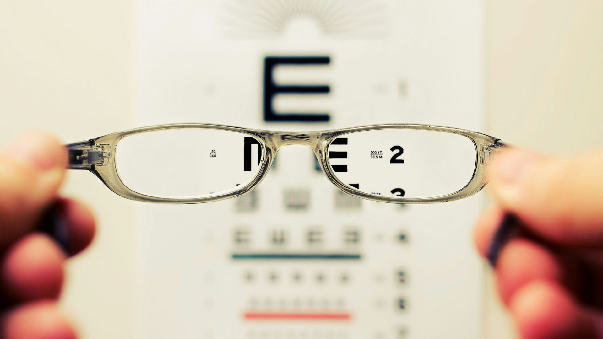 person holding eyeglasses