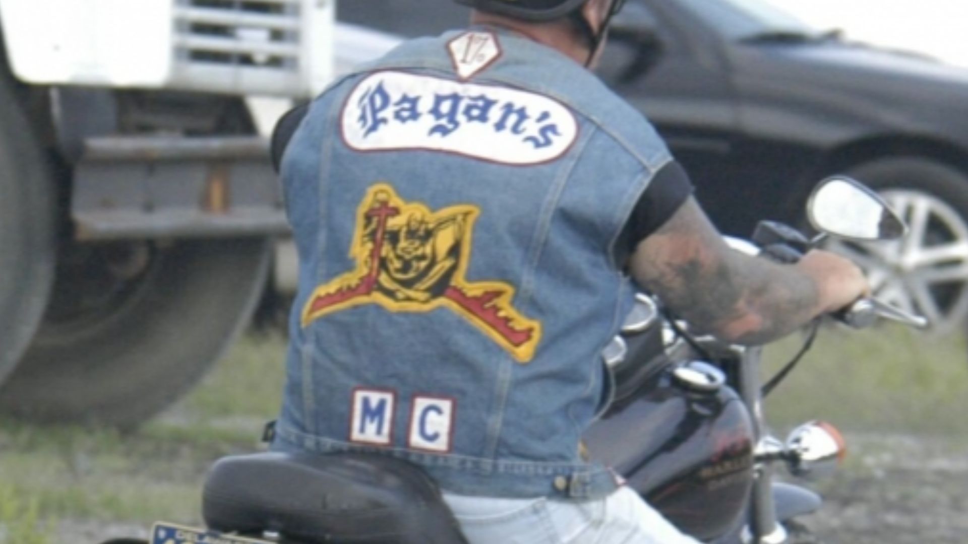 File:Pagans MC member on motorcycle.jpg