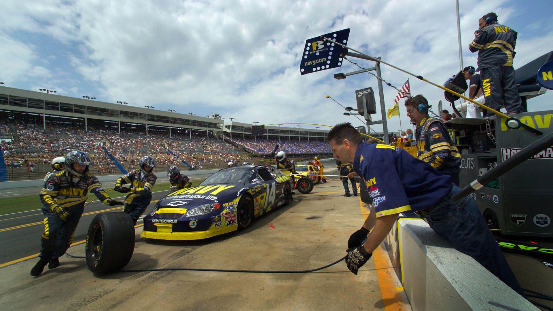 File:US Navy 040529-N-2383B-340 Team members of the FitzBradshaw NASCAR Busch Race Team change all four tires during a pit stop.jpg