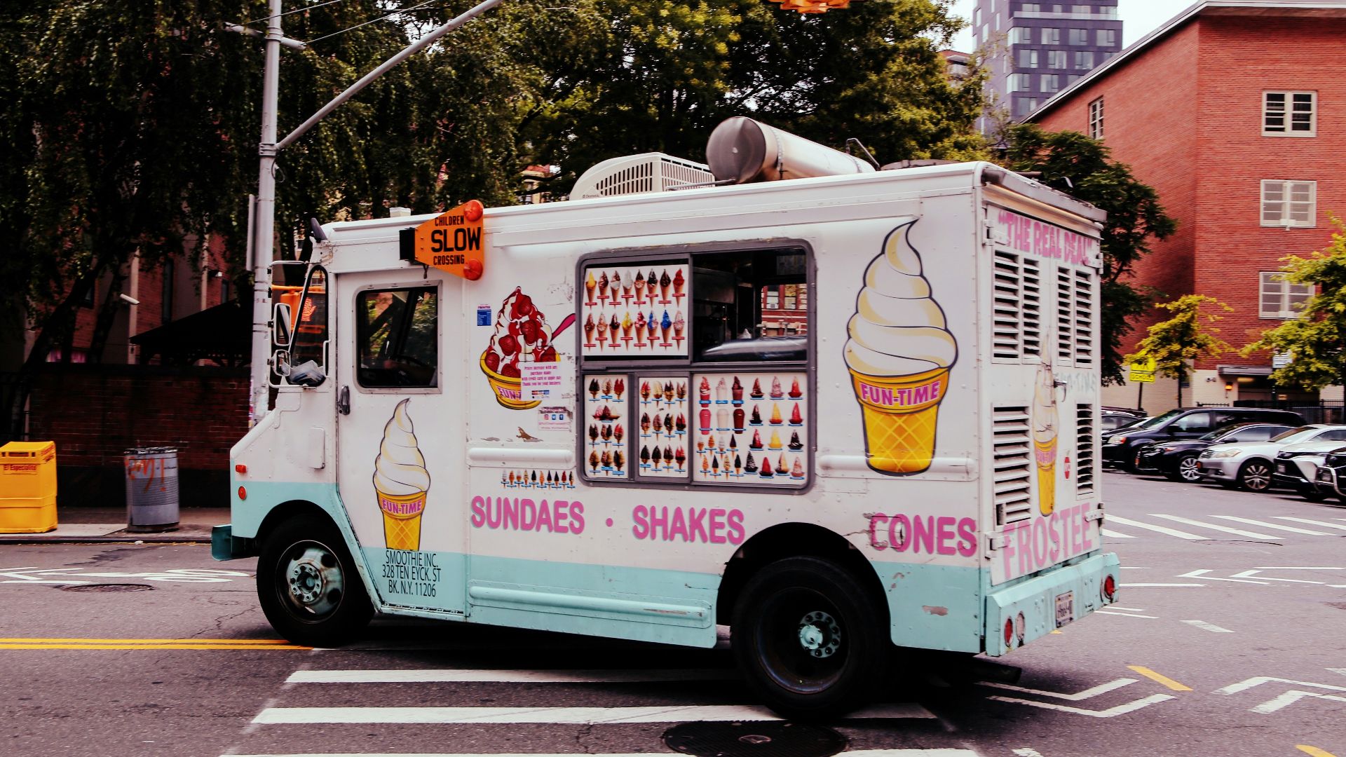 an ice cream truck is driving down the street