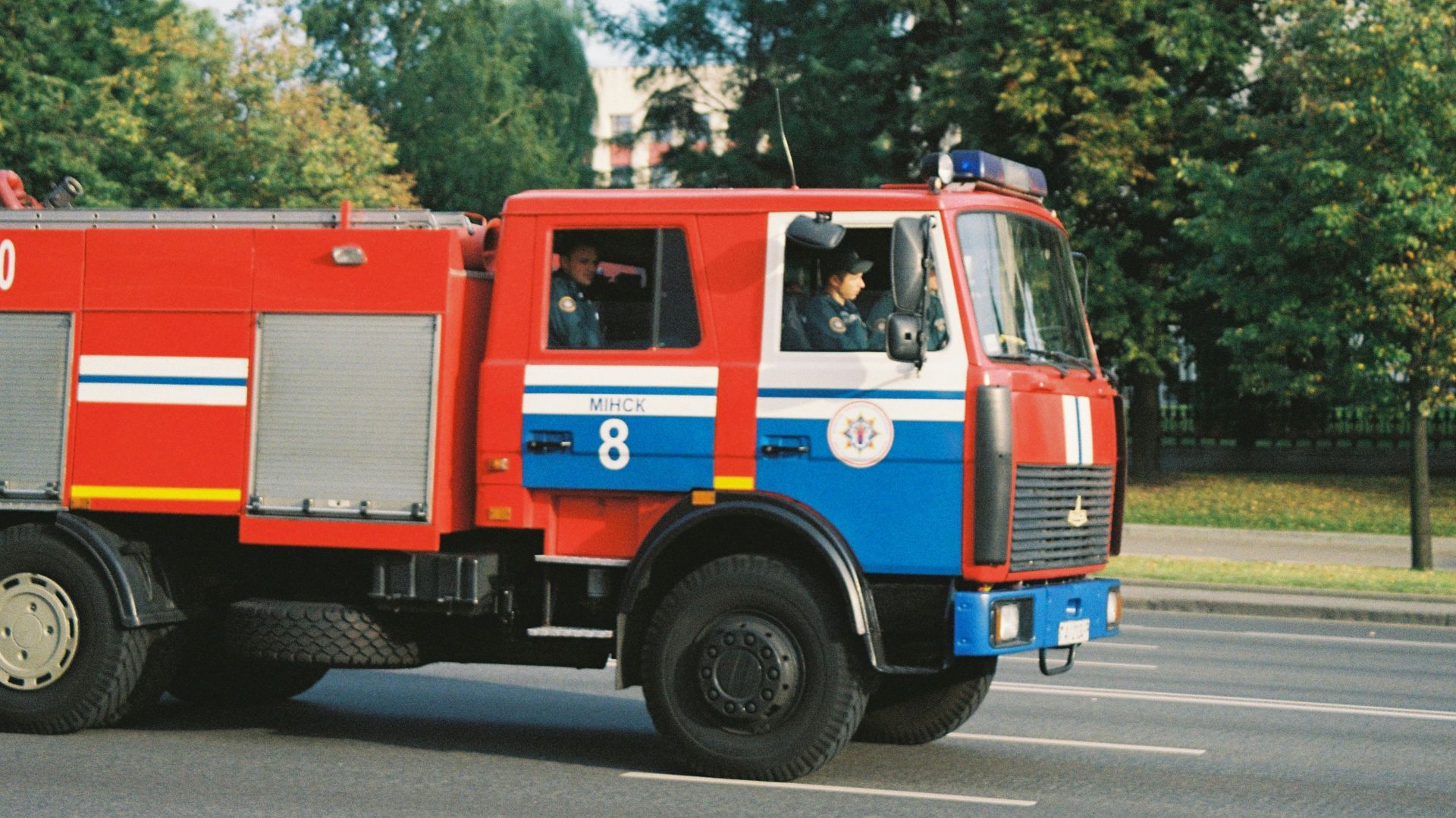 red and blue bus on road during daytime