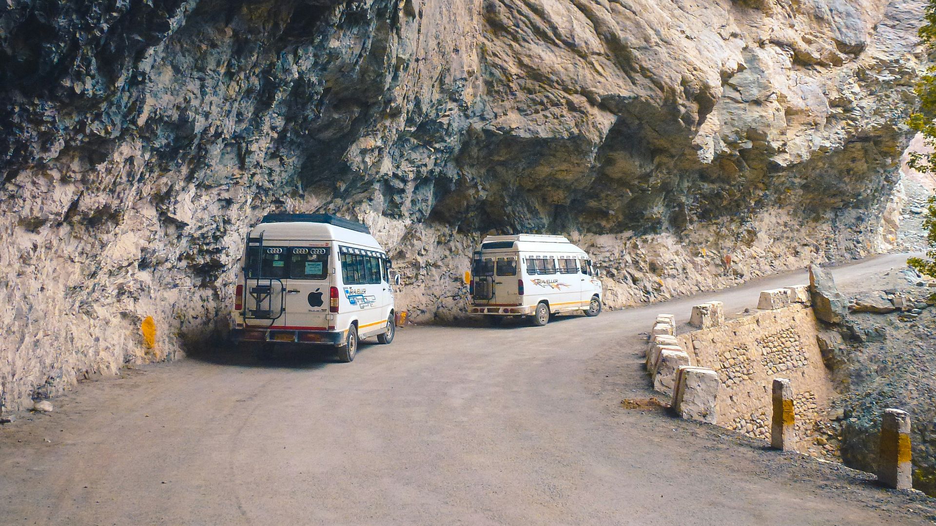 white van on road near rocky mountain during daytime