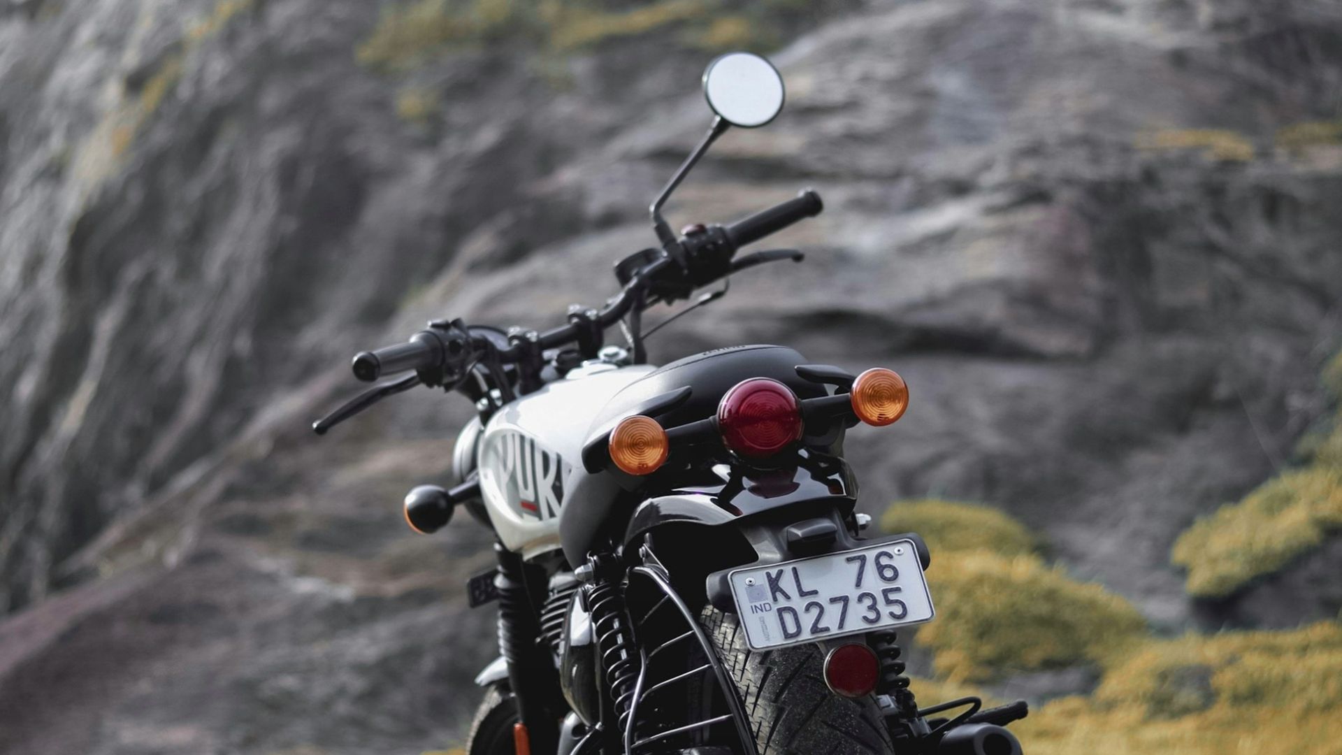a motorcycle parked on the side of a mountain