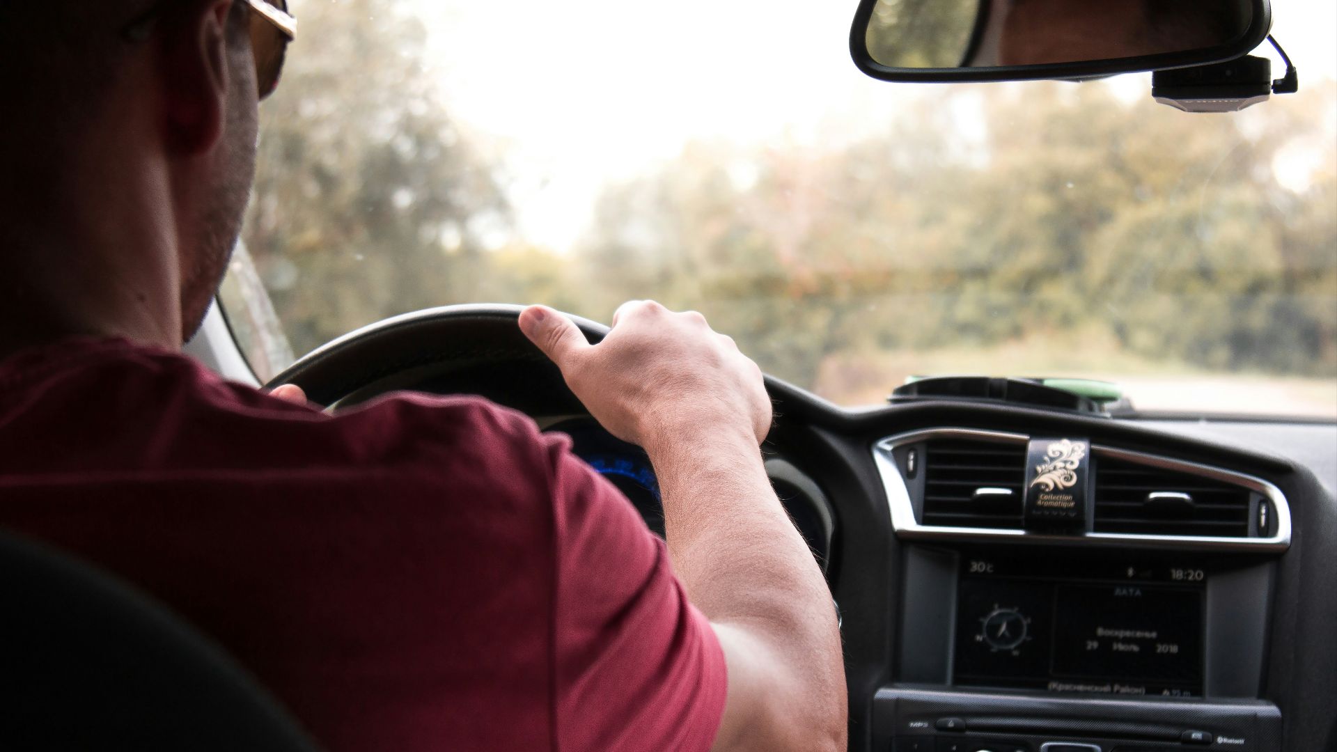 person driving car during daytime
