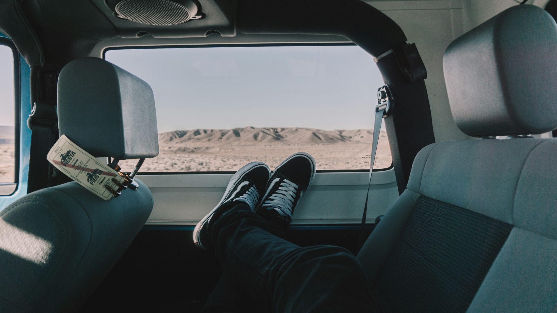 person's both feet on vehicle window