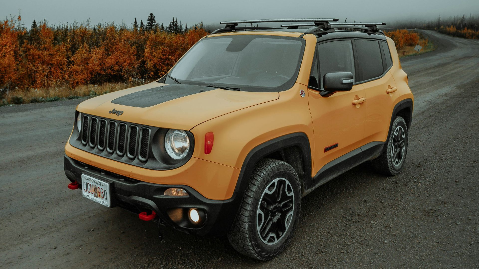 yellow and black jeep grand cherokee on road