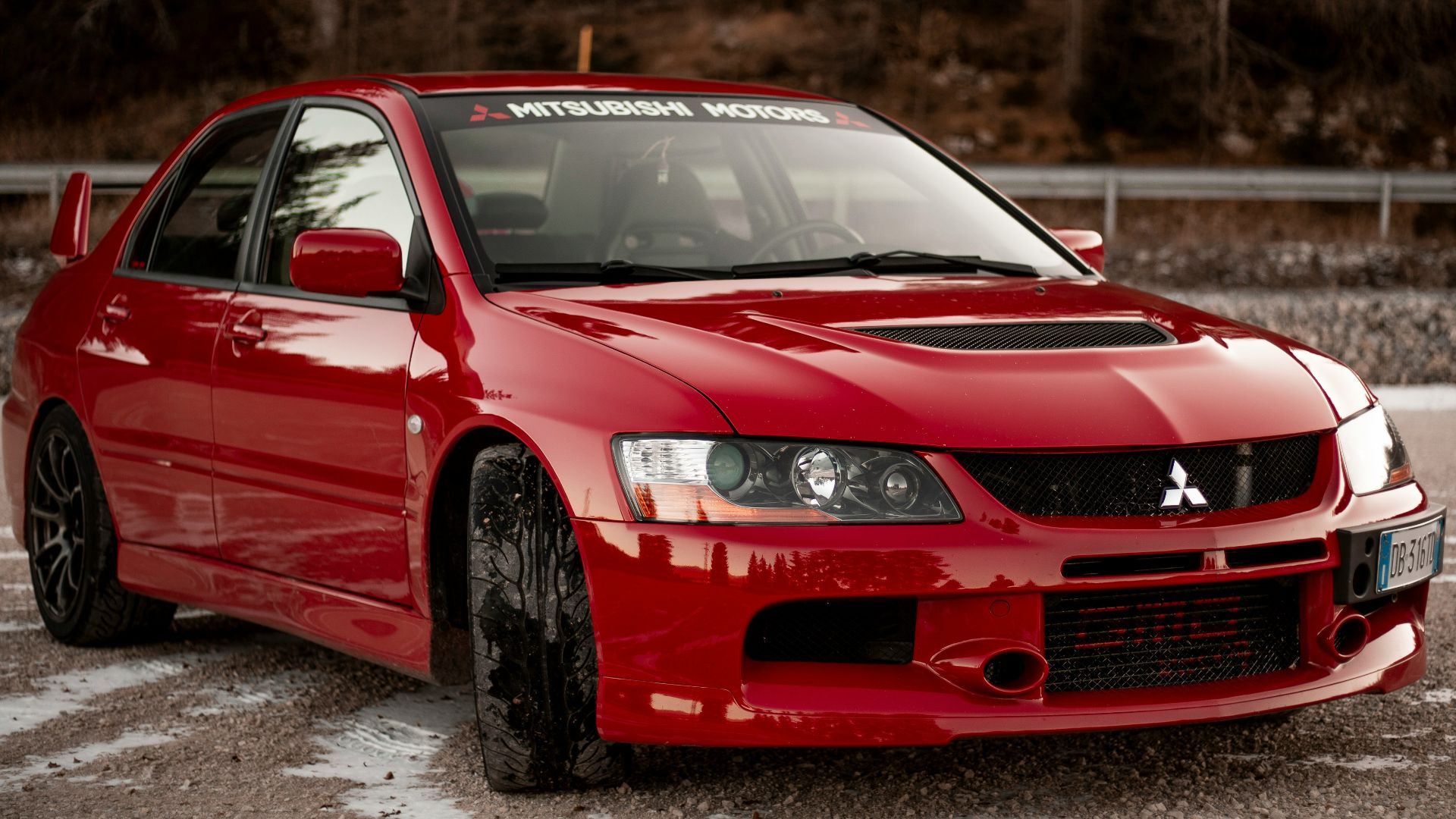 red chevrolet camaro on road during daytime