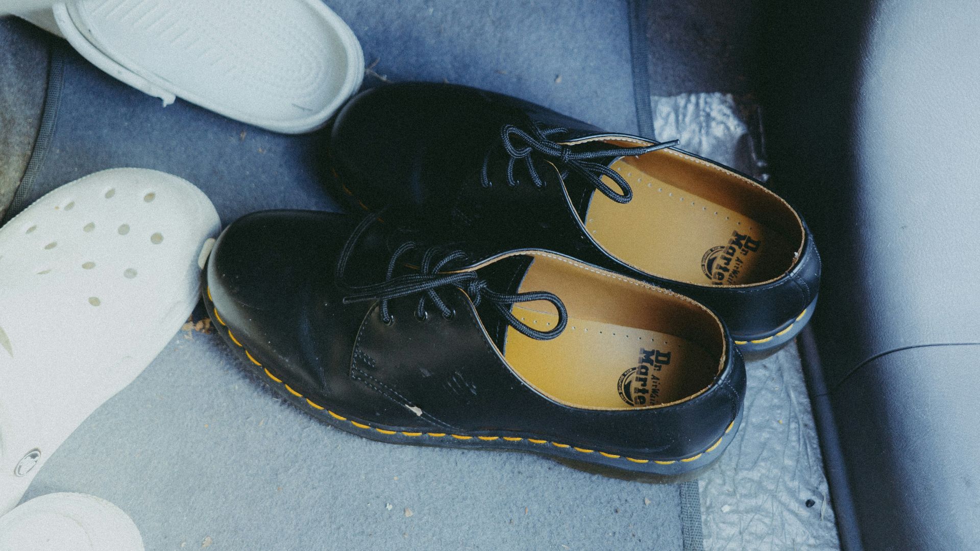 A pair of shoes sitting on the floor of a car