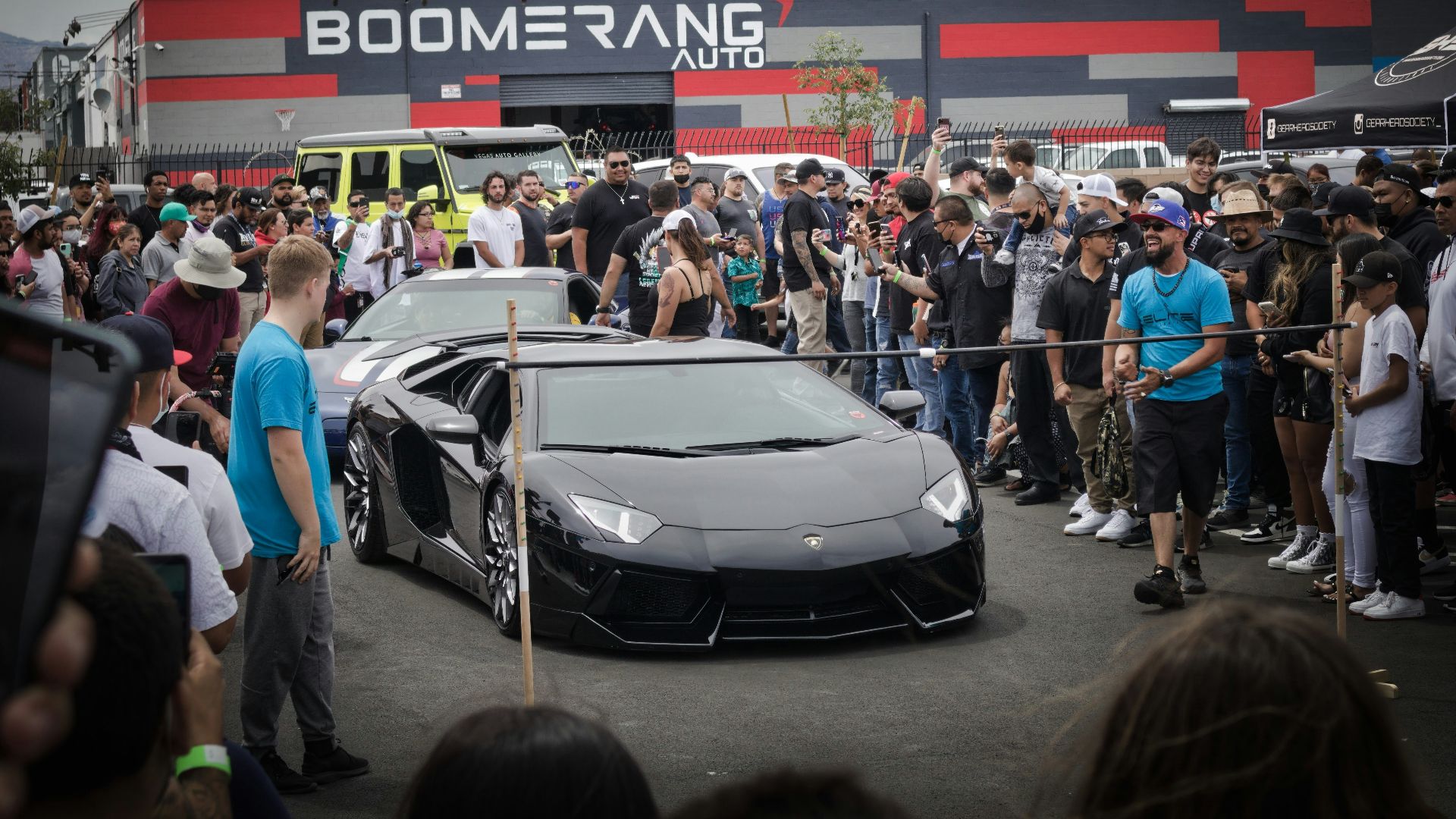 people standing near white and black car